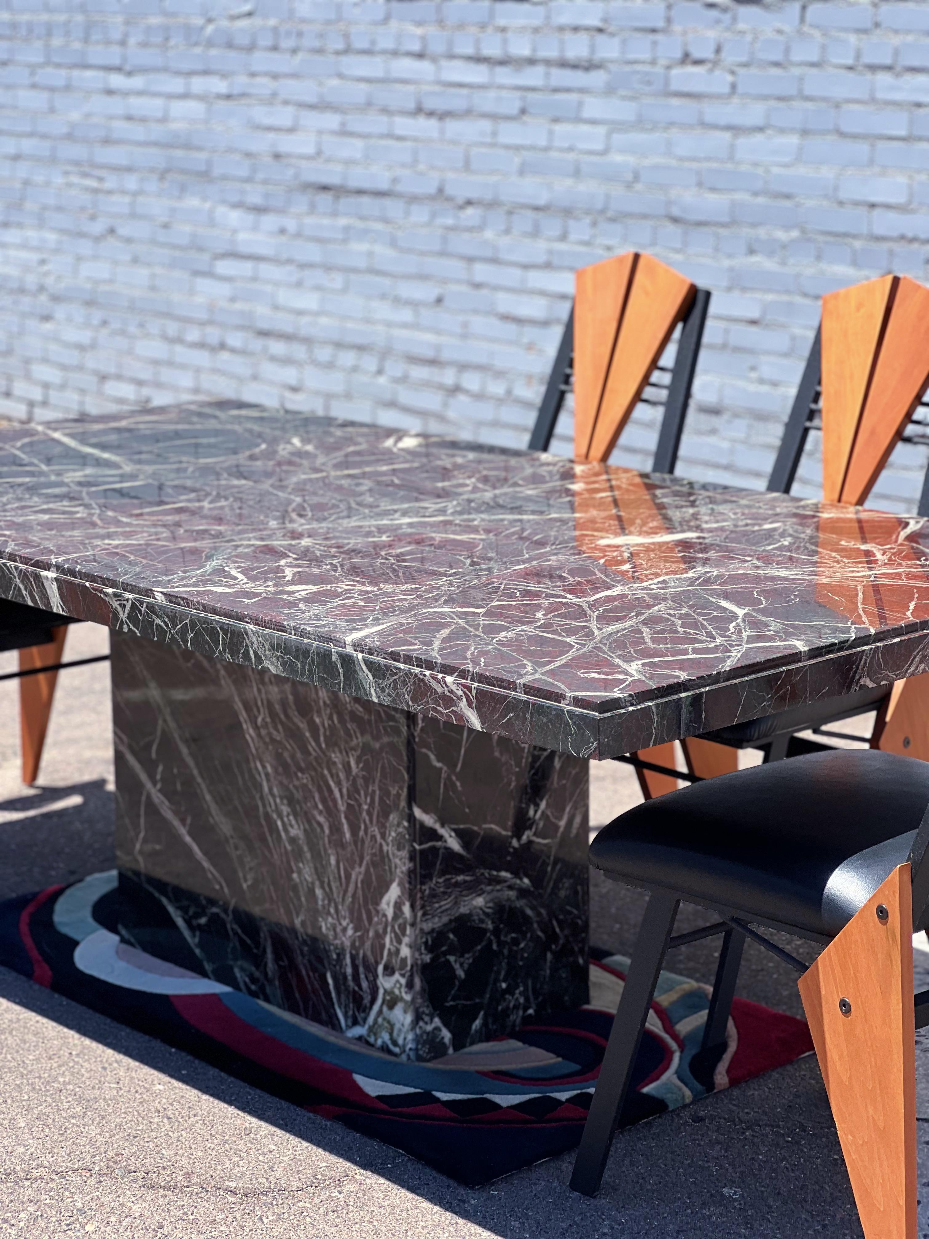 Exquisite piece of Rosso Levanto marble fabricated in Italy circa 1970's into a statement dining table. Incredible detail throughout. 

This piece brags areas of deep red, emerald green, and off-white veining that gives the table a look of texture