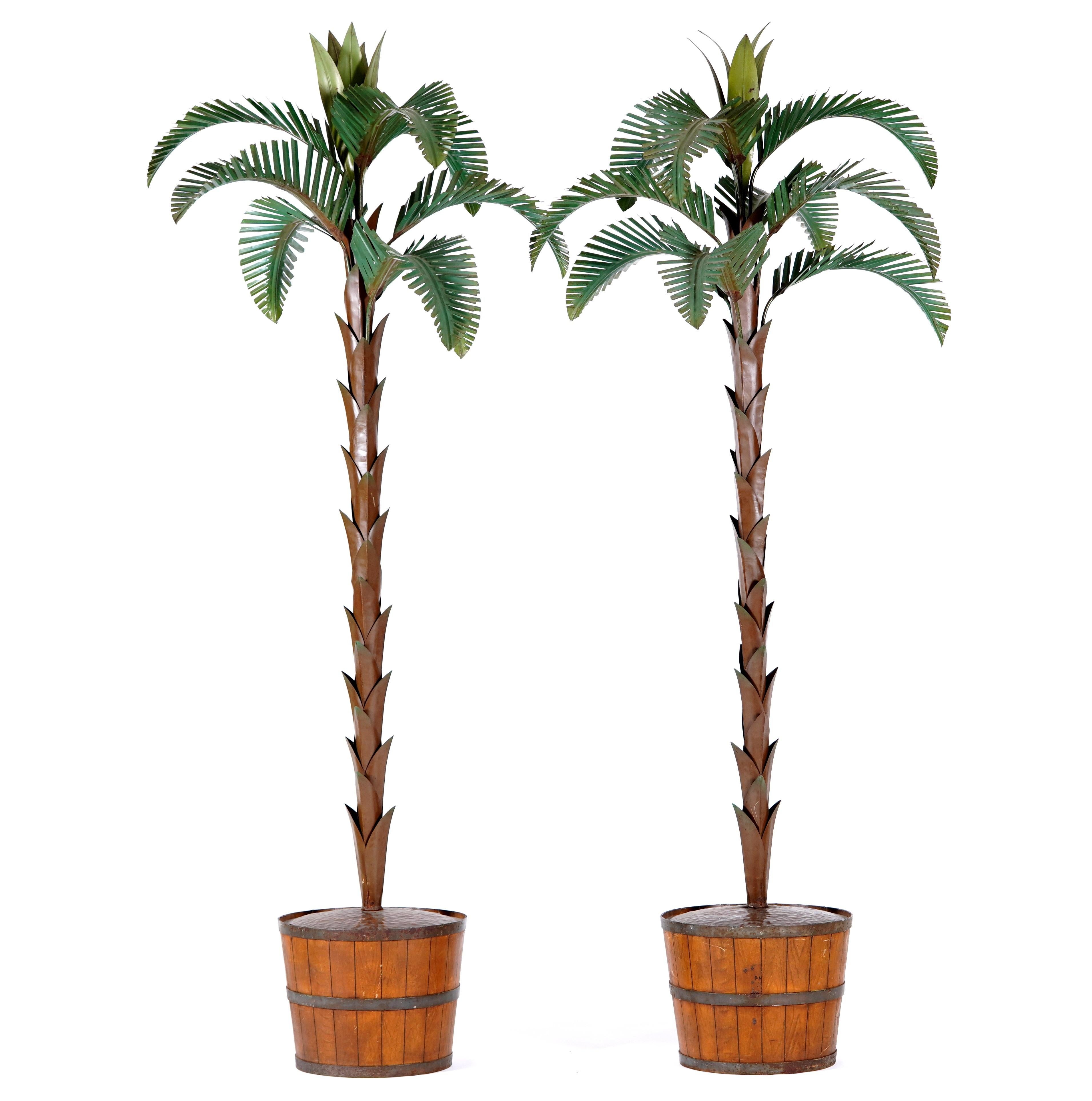 Very unusual being free standing. Each with weighted faux bois pots with natural wood grain and strapping. The palms with oxidized copper trunks with green painted detachable palm fronds. Would be fantastic on either side of a doorway. From a