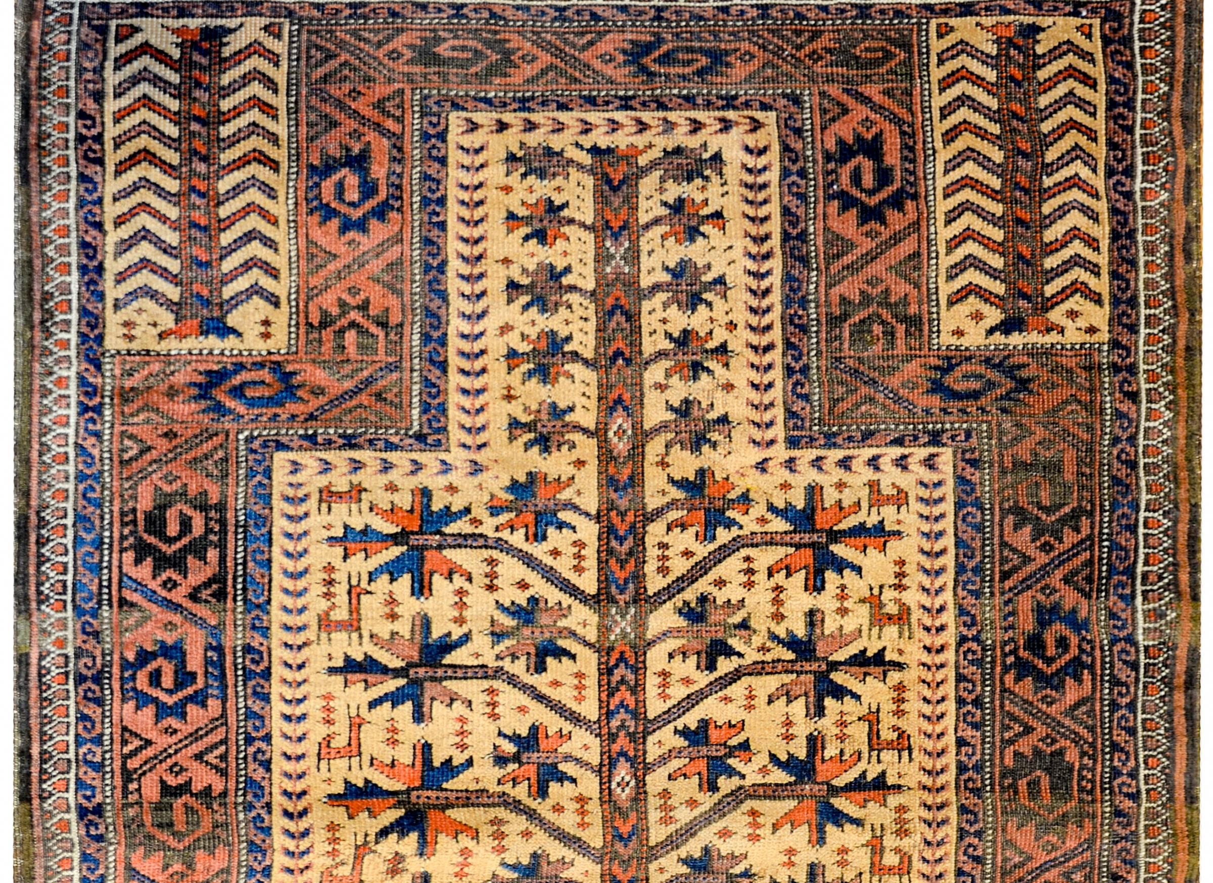 An incredible late 19th century Persian Baluch prayer rug with an all-over large-scale tree-of-life pattern woven with indigo, crimson, and brown wool on a gold colored background containing myriad goats hidden amidst the tree branches. The border