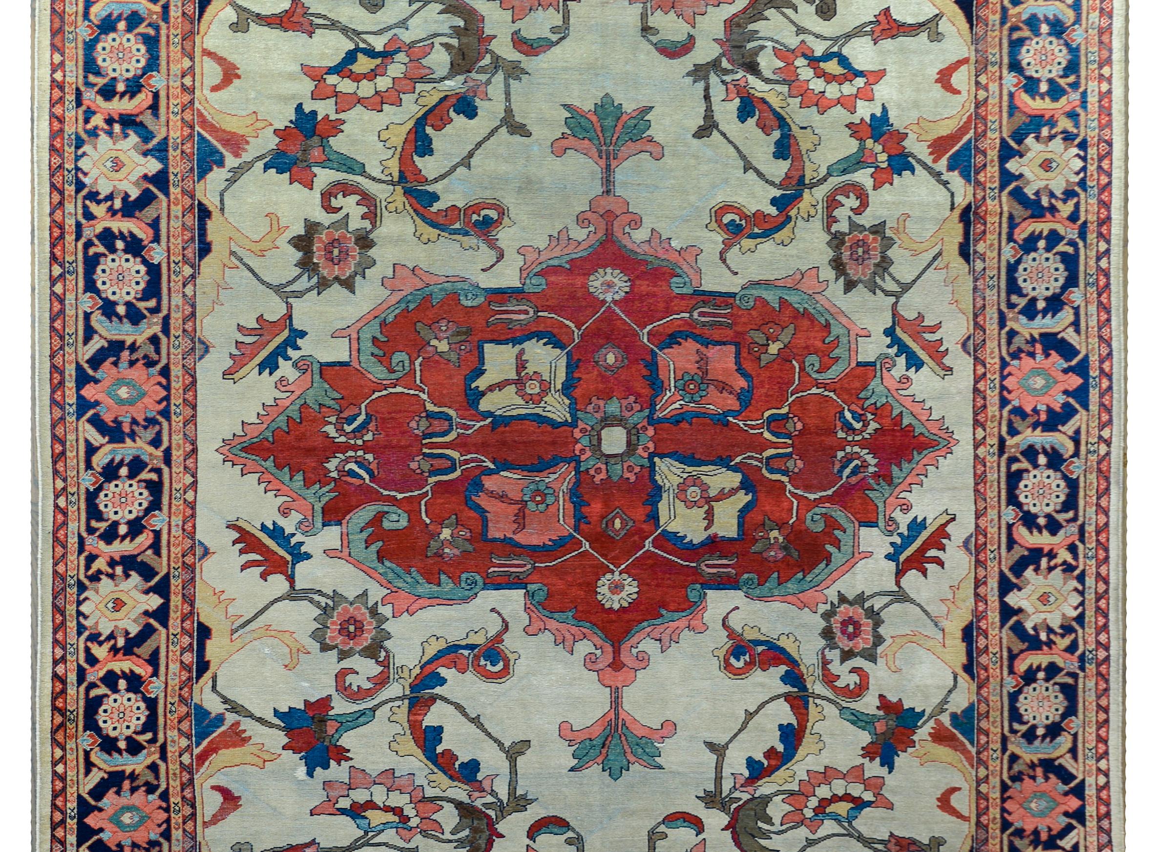 An incredible late 19th century Persian Sultanabad with the best large-scale crimson medallion with stylized flowers and scrolling vines, against a white background with more scrolling leaves and flowers. The border is wide with even more