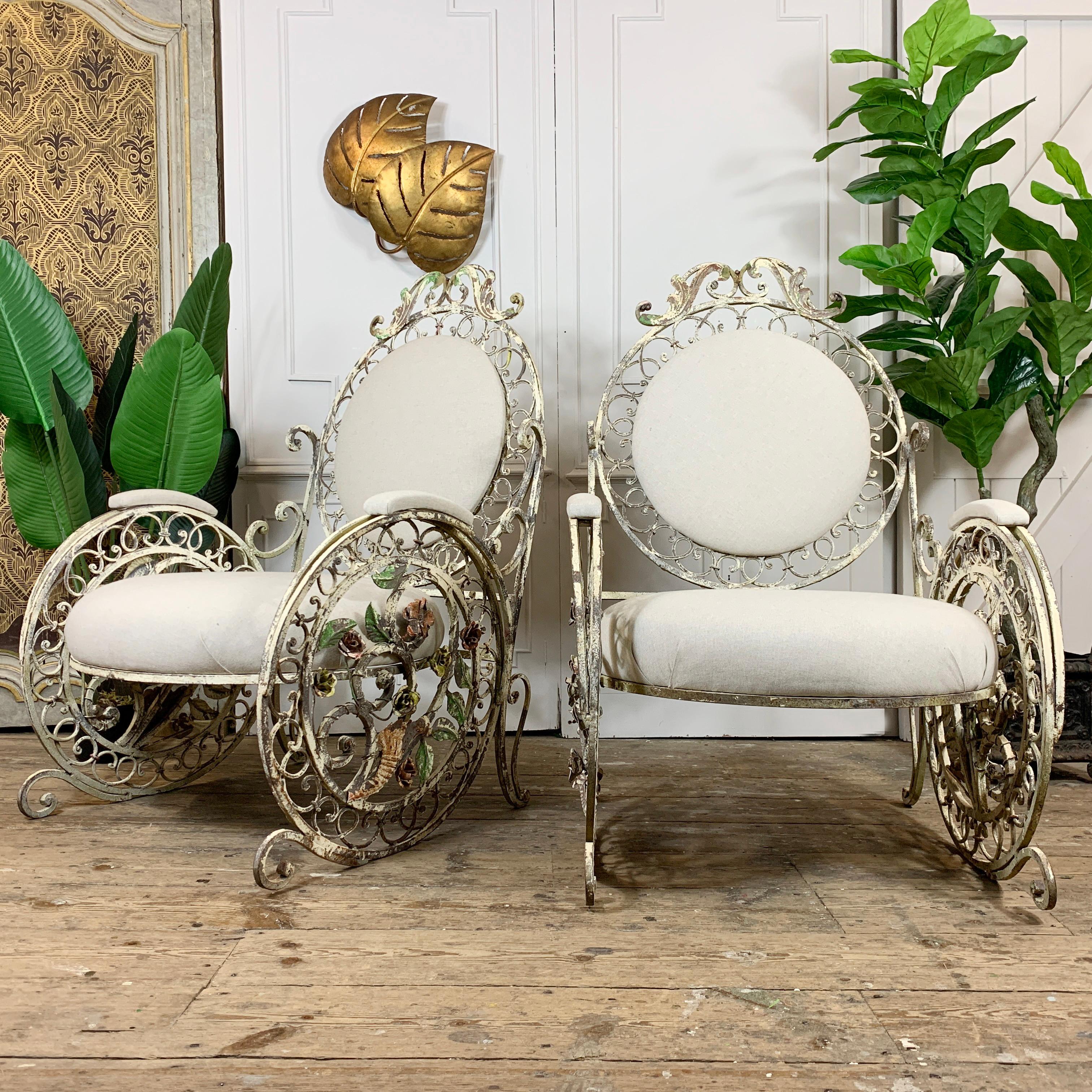 A quite exceptional late 19th century pair of French patio/orangery chairs.

This is a beautiful wrought iron pair of large chairs, with the most intricate decorative detailing and workmanship throughout. An abundance of flowers and leaves