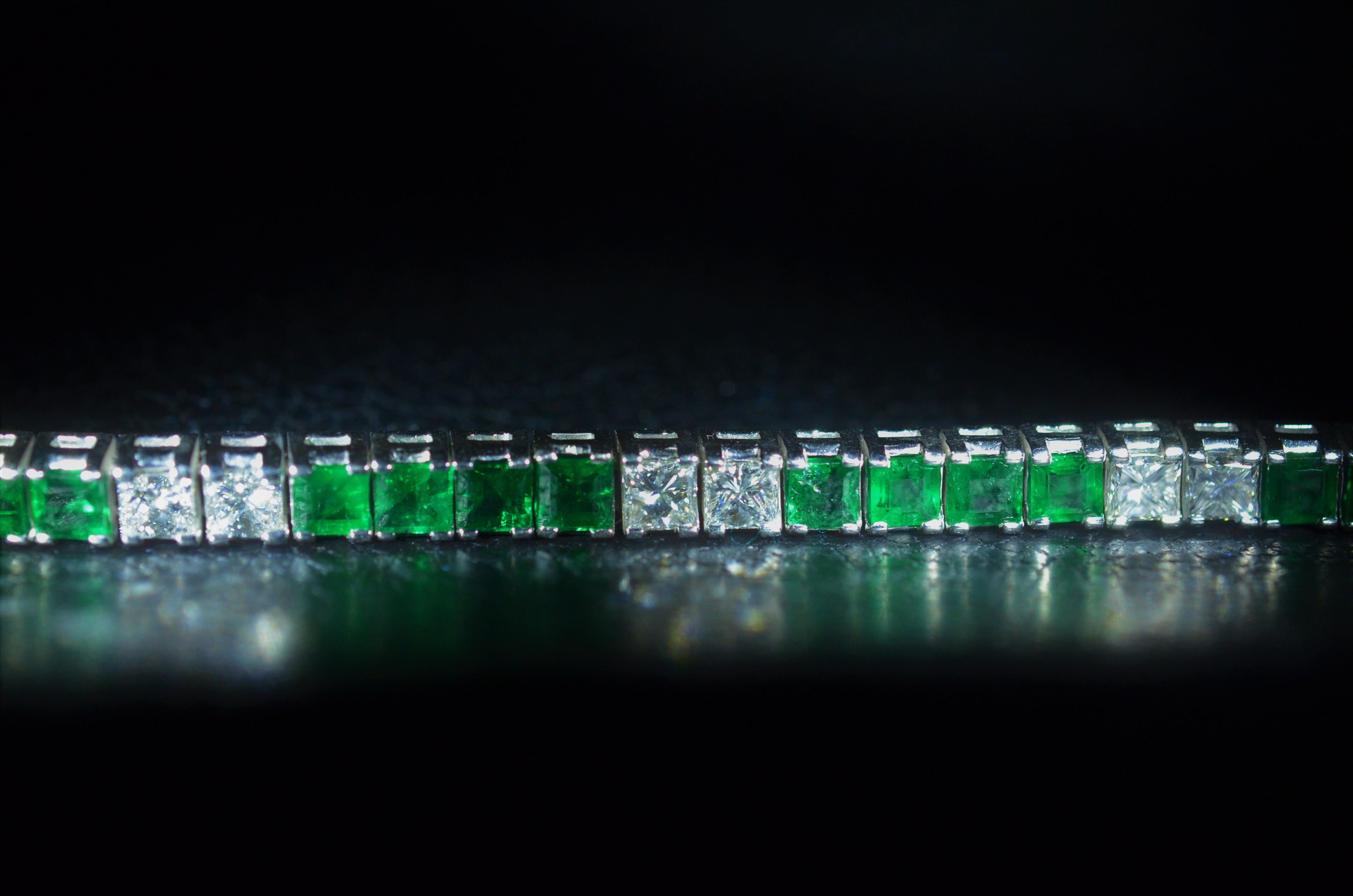 Exquisite ladies platinum line bracelet set with alternating sections of vivid bluish-Green emeralds and diamonds. The estimated total diamond weight by measurement is 7.20 carats. The estimated emerald weight by measurement is 9.80 carats. The