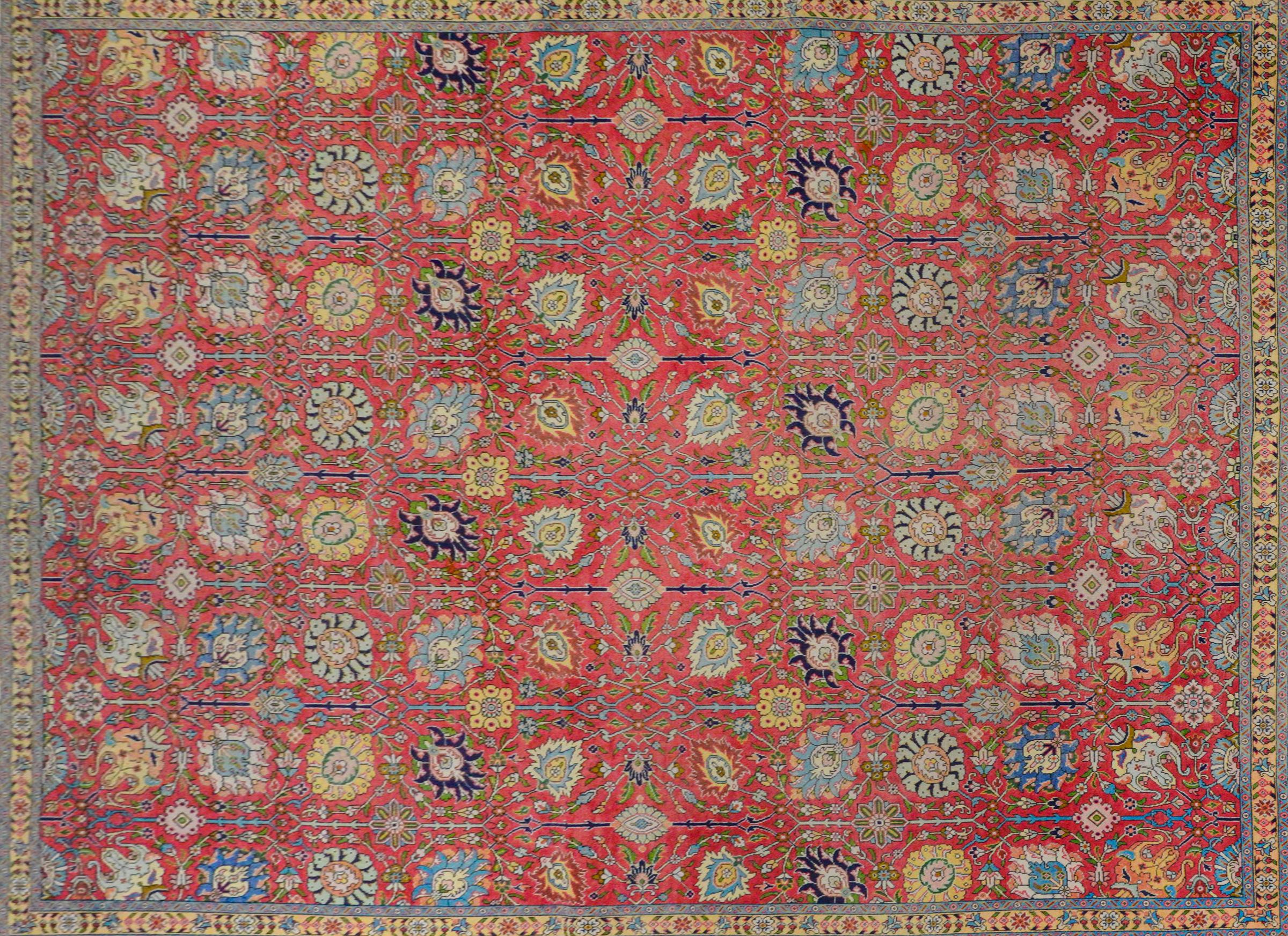 An incredible mid-20th century Persian Tabriz with an outstanding trellis floral and scrolling vine pattern woven in brilliant turquoise, lime greens, bright yellows, all on a bright pink background. The border is also outstanding with a large