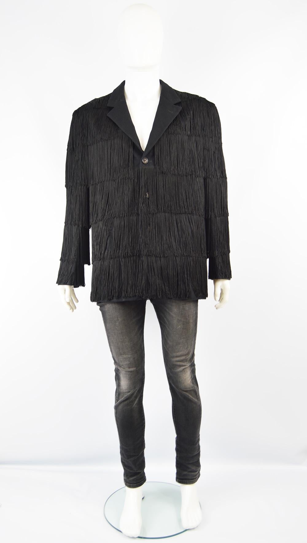 A rare and amazing vintage men's jacket from the 90s by genius Italian fashion designer, Moschino for his men's Cheap & Chic line. Made in Italy, in a black wool blend with original fringing that creates an edgy and dramatic look. Would make such a