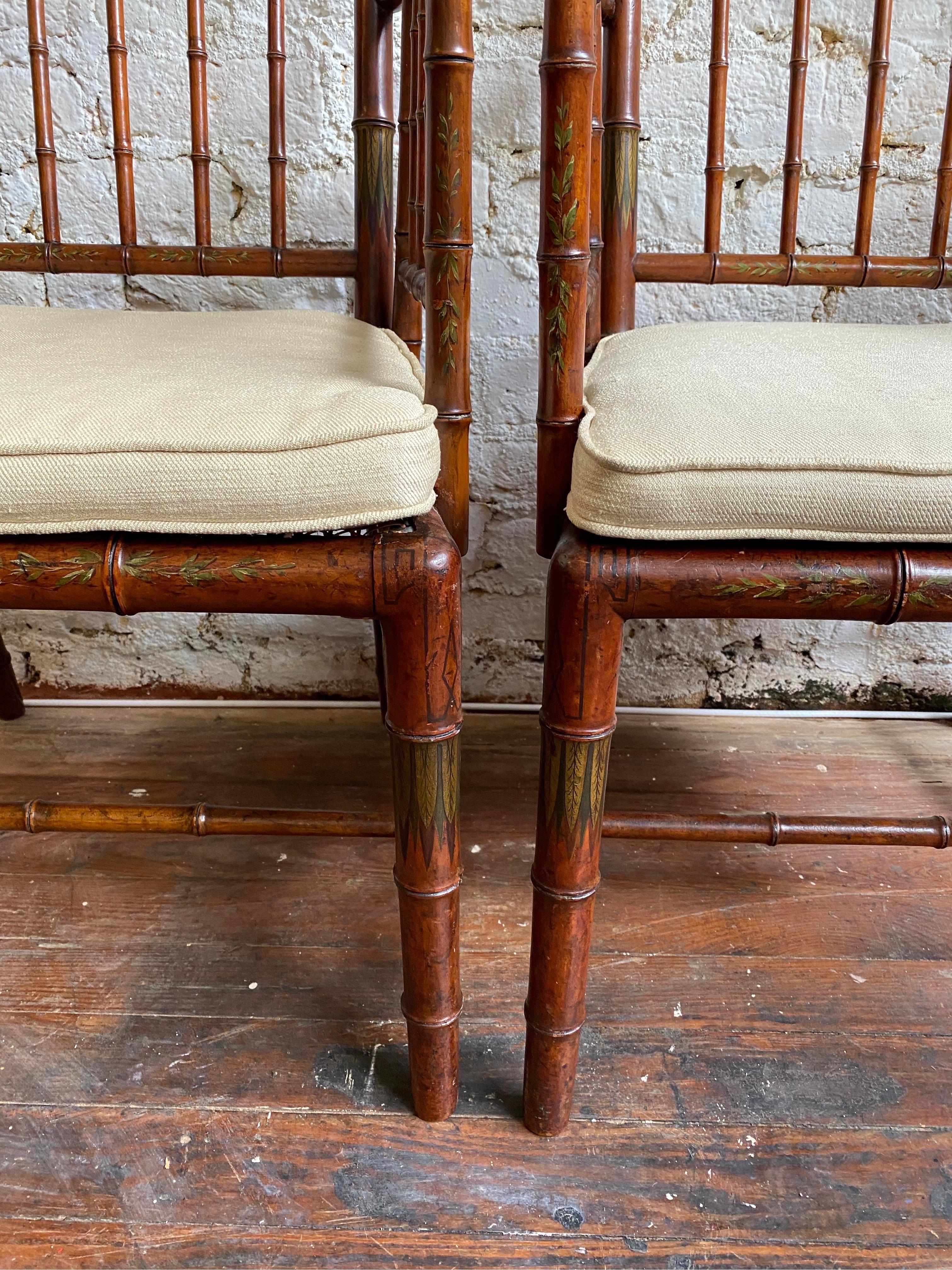 Incredible pair of 19th century faux bamboo armchairs with polychrome paint decoration. Chairs are very good quality and are in excellent condition. There are 2 removable cushions that add about 1.5-2