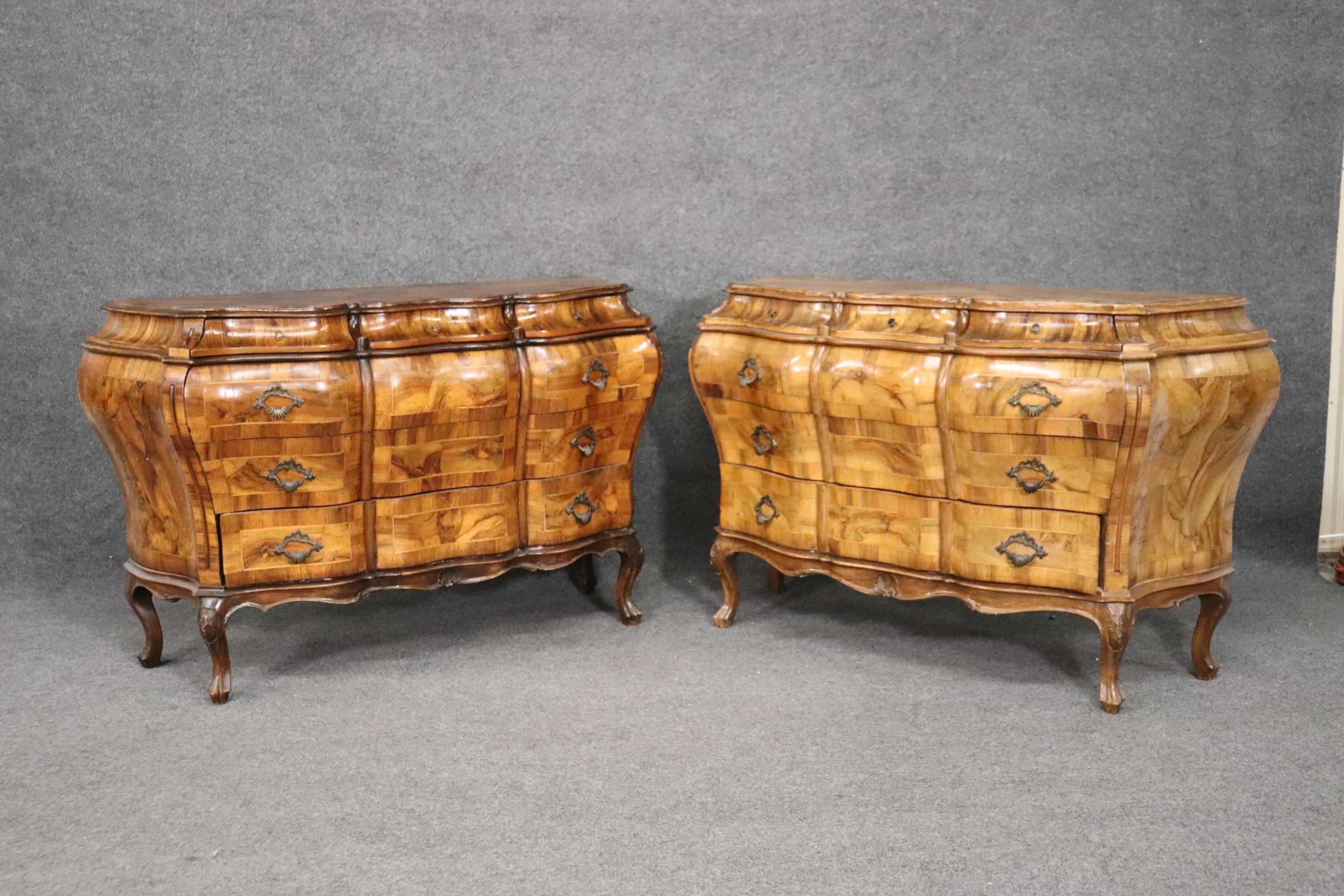 This is a matched pair of Italian olivewood commodes. They are a matched pair though the color of one is slightly fade from years of being in the sun. The commodes measures 52 wide x 32 tall x 19 inches deep. They date to the 1920-30s era and are in