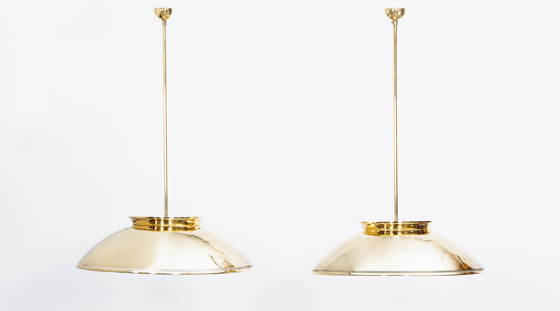 Pair of pendant lamps, brass, glass Paavo Tynell, Finland, 1950.

Fantastic set of ceiling lamps by Finland classic Paavo Tynell. His cautious hand in light design comes to full effect through this elegant yet unobtrusive set of ceiling lamp with