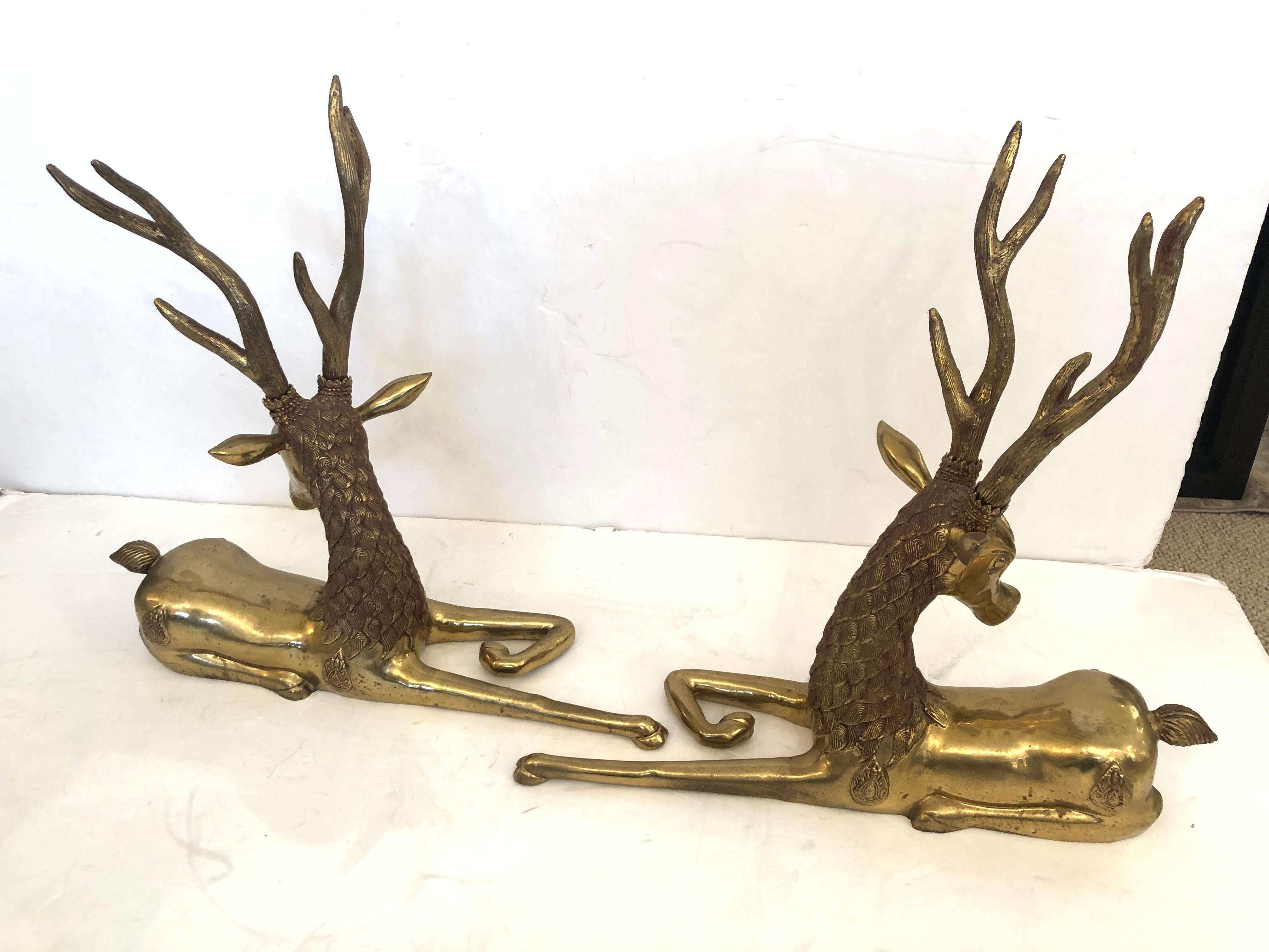 An impressive pair of vintage solid brass opposing reclining stags having beautiful detailed casting and fabulous large antlers.