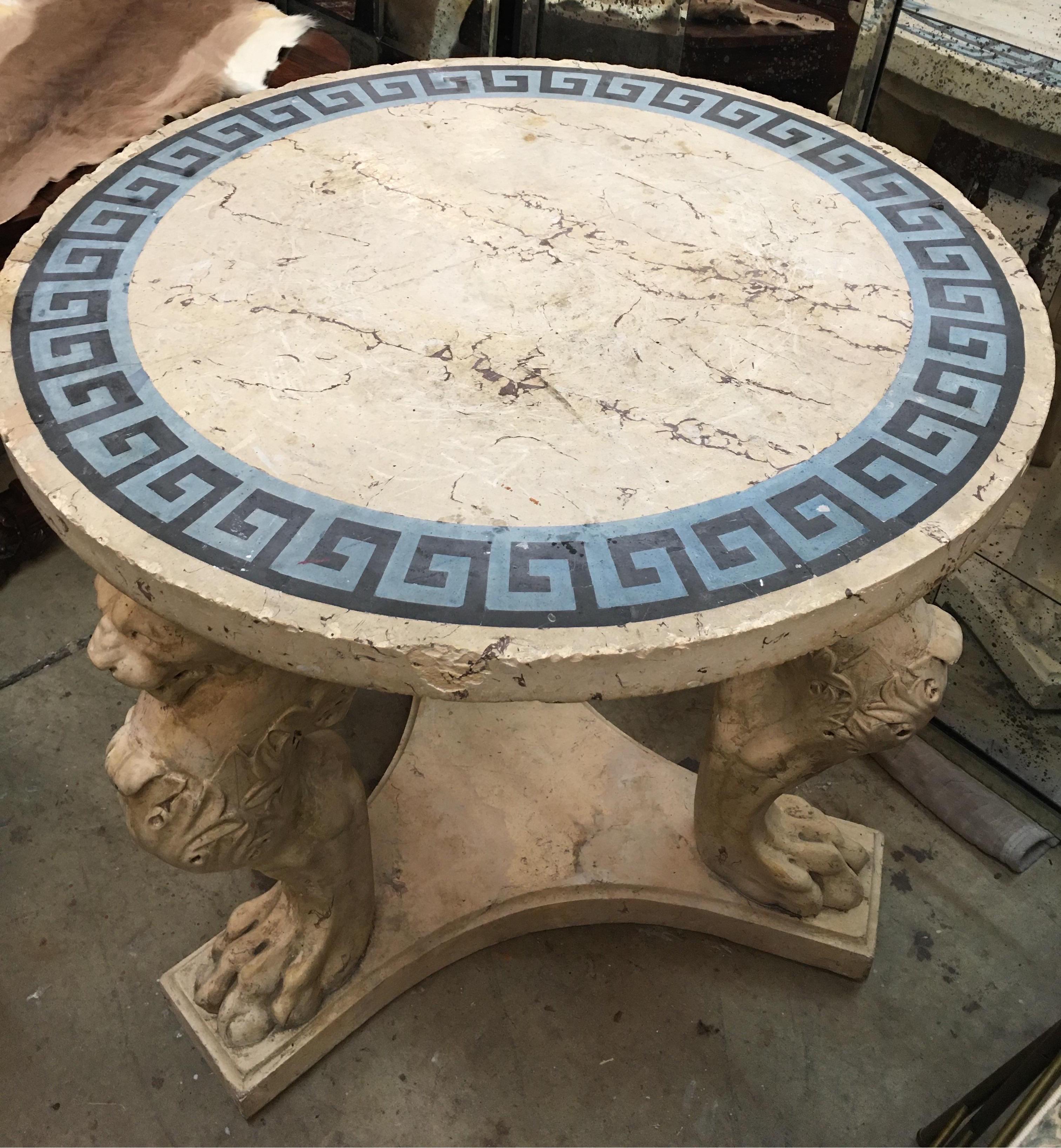 Incredible rare 19th century Italian Grand Tour scagliola center table. 

 The classical inspired table features the Greek key decorated lintel top supported by a tryptich of monopods with intricately carved lion faces and terminates in a platform