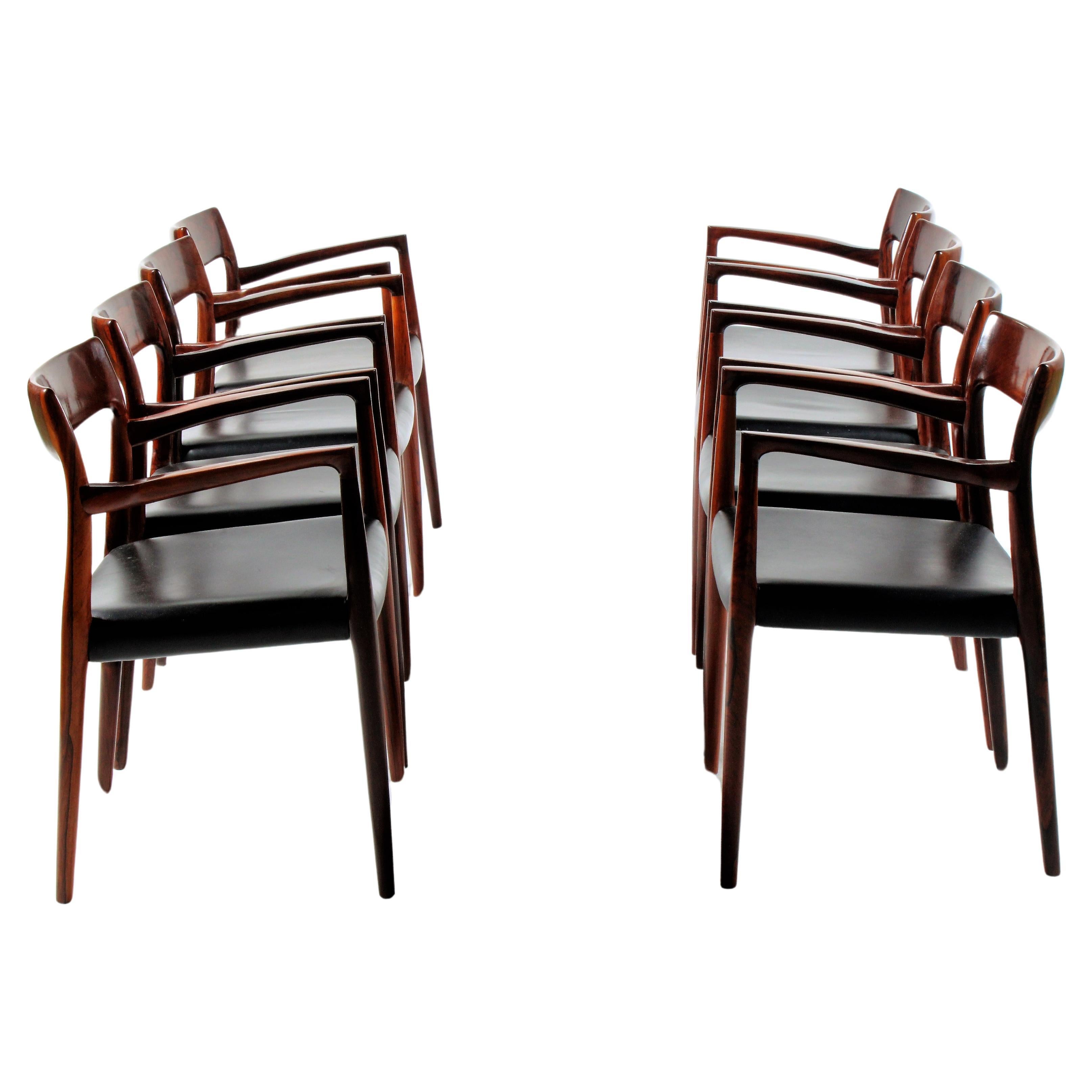 An incredibly rare and beautiful set of eight Model 57 armchairs by Niels Otto Moller for  for J.L. Møller Mobelfabrik, Denmark dating from 1959. These chairs are made from exquisite rosewood with the most amazing grain pattern and the chair seats
