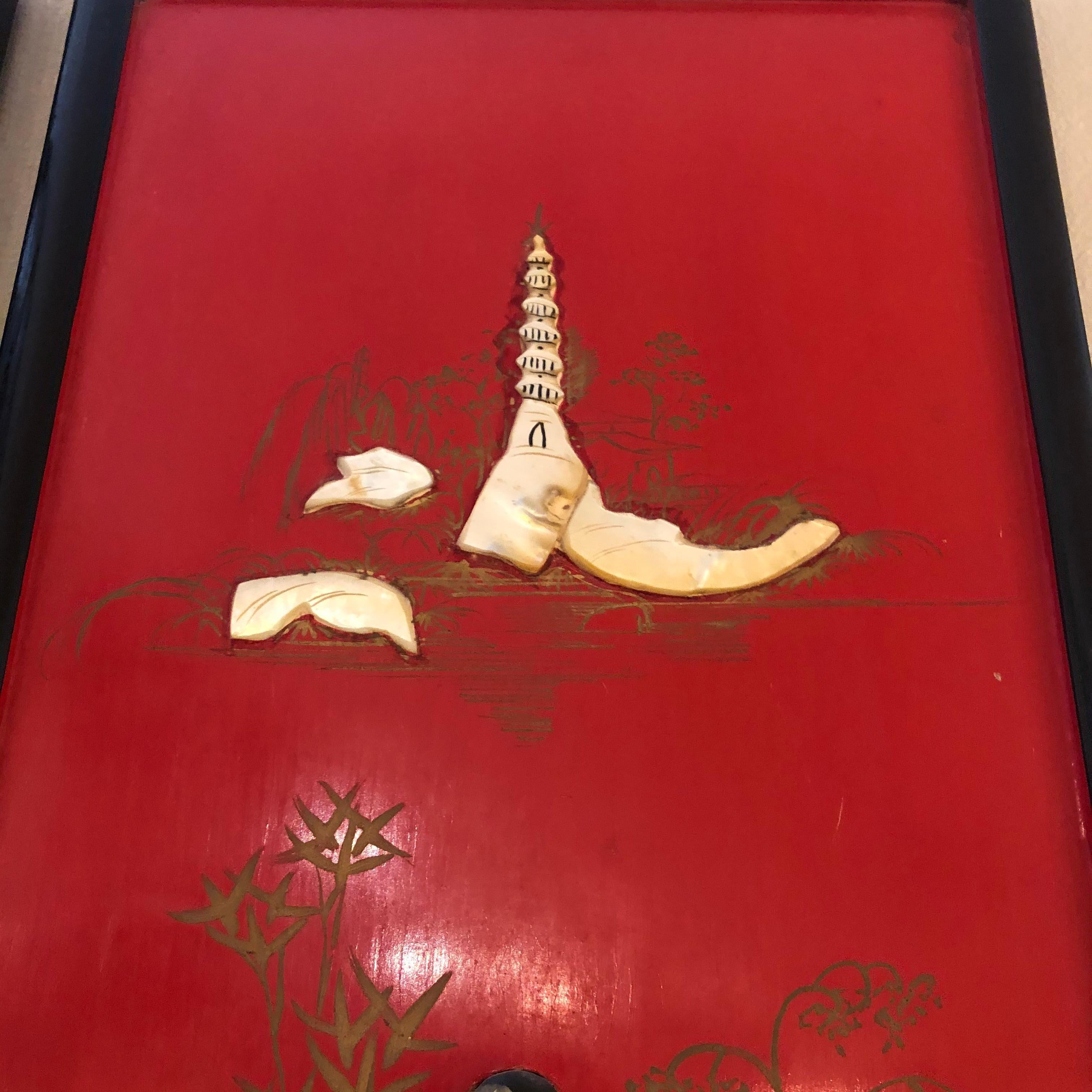 Incredible Asian artwork consisting of 4 rectangular vertical panels having meticulous mother of pearl relief against a fabulous red painted background. There are four lovely figural couples, a pagoda and subtle gilded trees in the