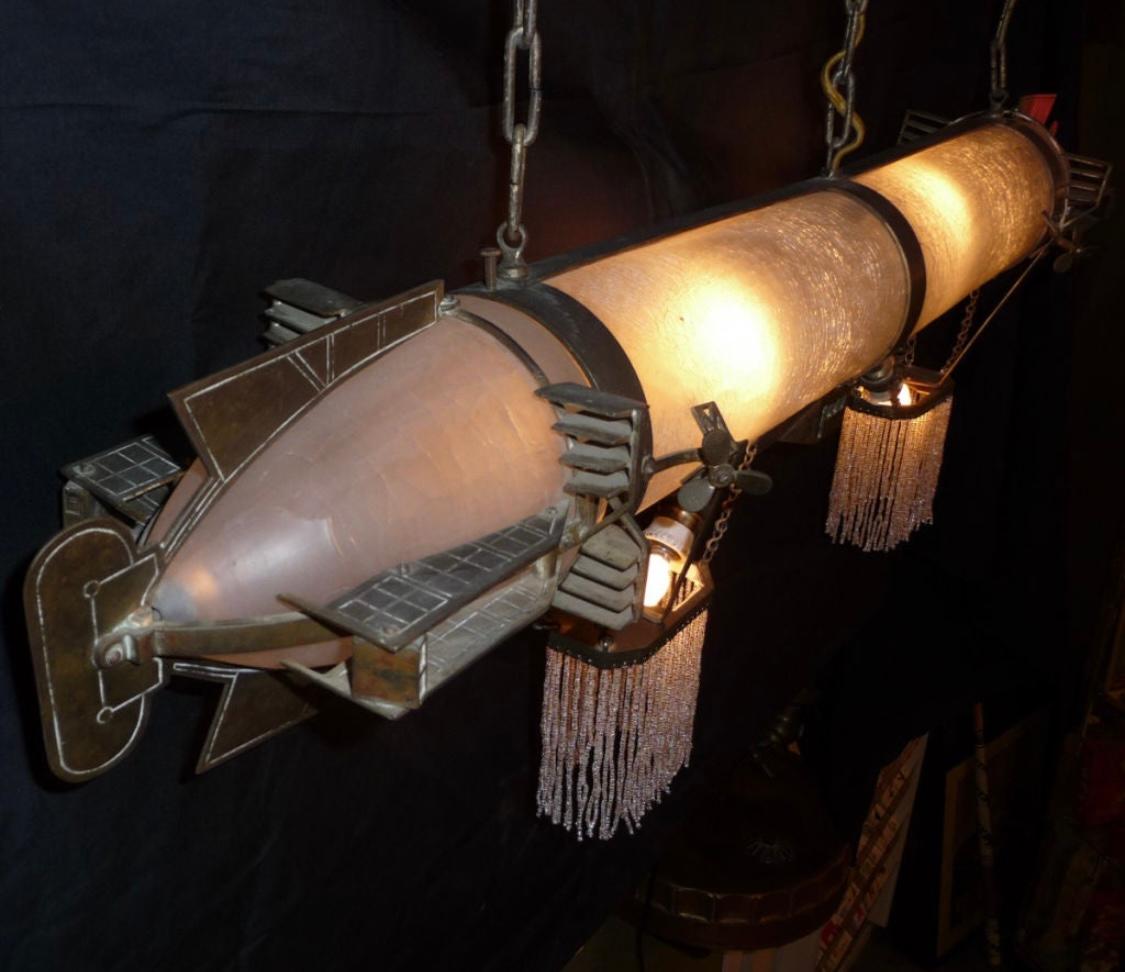 An unbelievable work of art, disguised as a lamp! The origins are unknown here, but it may have been created for an airship executives office. The body is frosted crackled glass, with the ends removable for bulb access. Great detail is displayed