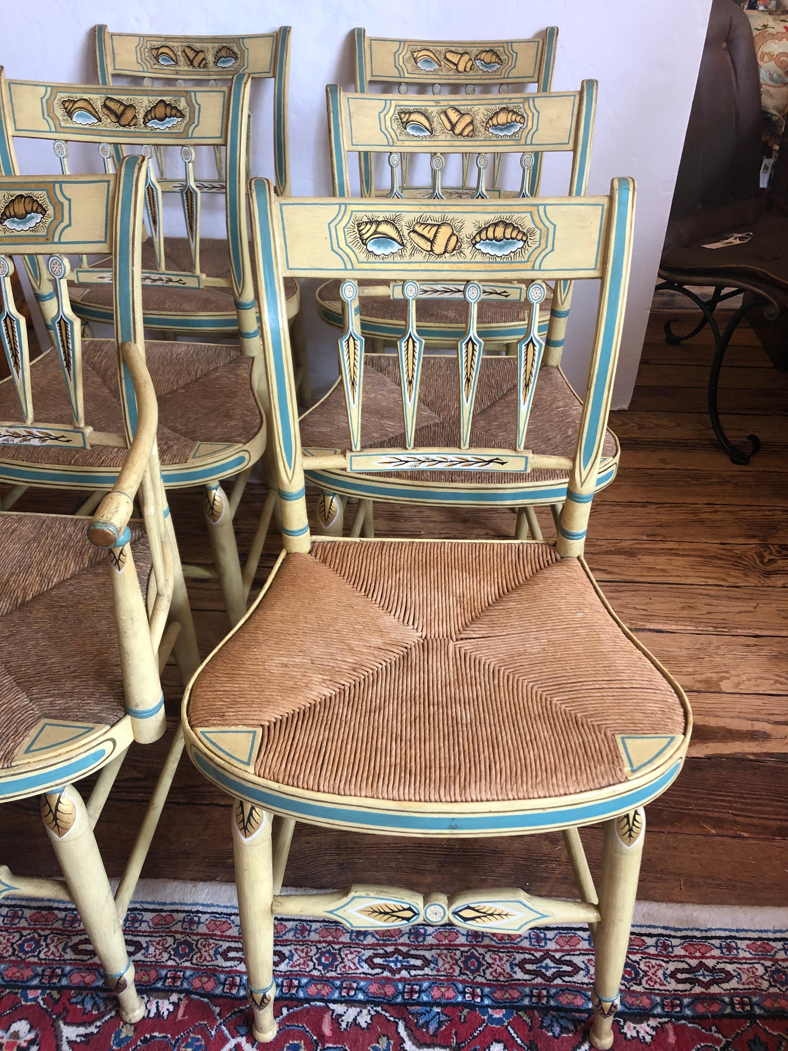 Charming timeless casual country set of Hitchcock antique dining chairs, handpainted in light yellow and teal with darling shell decoration and rush seats. One armchair, 5 sides.
Measures: seat height 18
Arm chair 20.5 W 17 D 33.25 H arm height