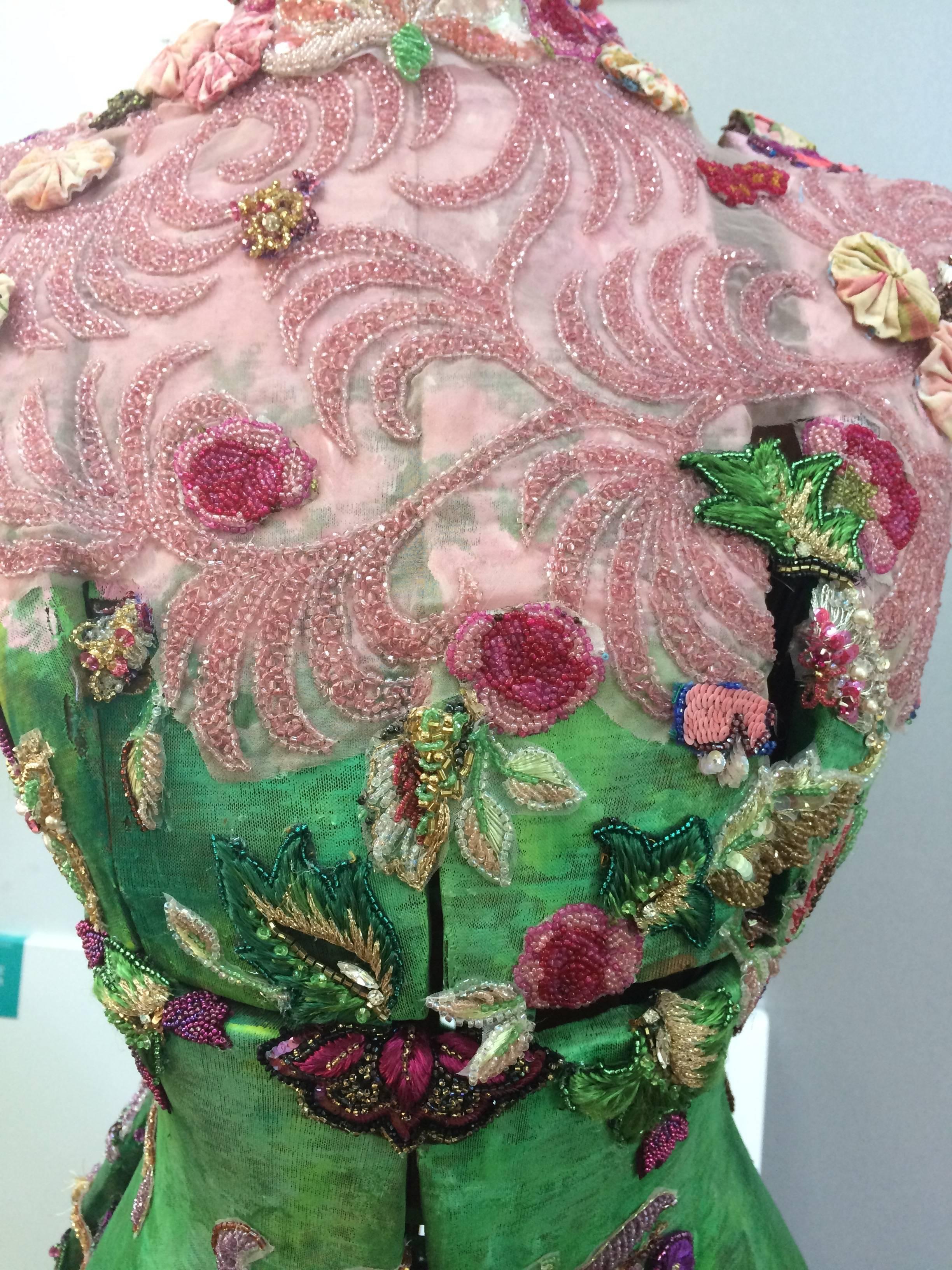 A gorgeously imaginative mixed-media assemblage sculpture that captures the vitality and colors of a Spring garden inspired by the magnolia tree in bloom outside the artist's studio. The object is a vintage dress form that has been painted and