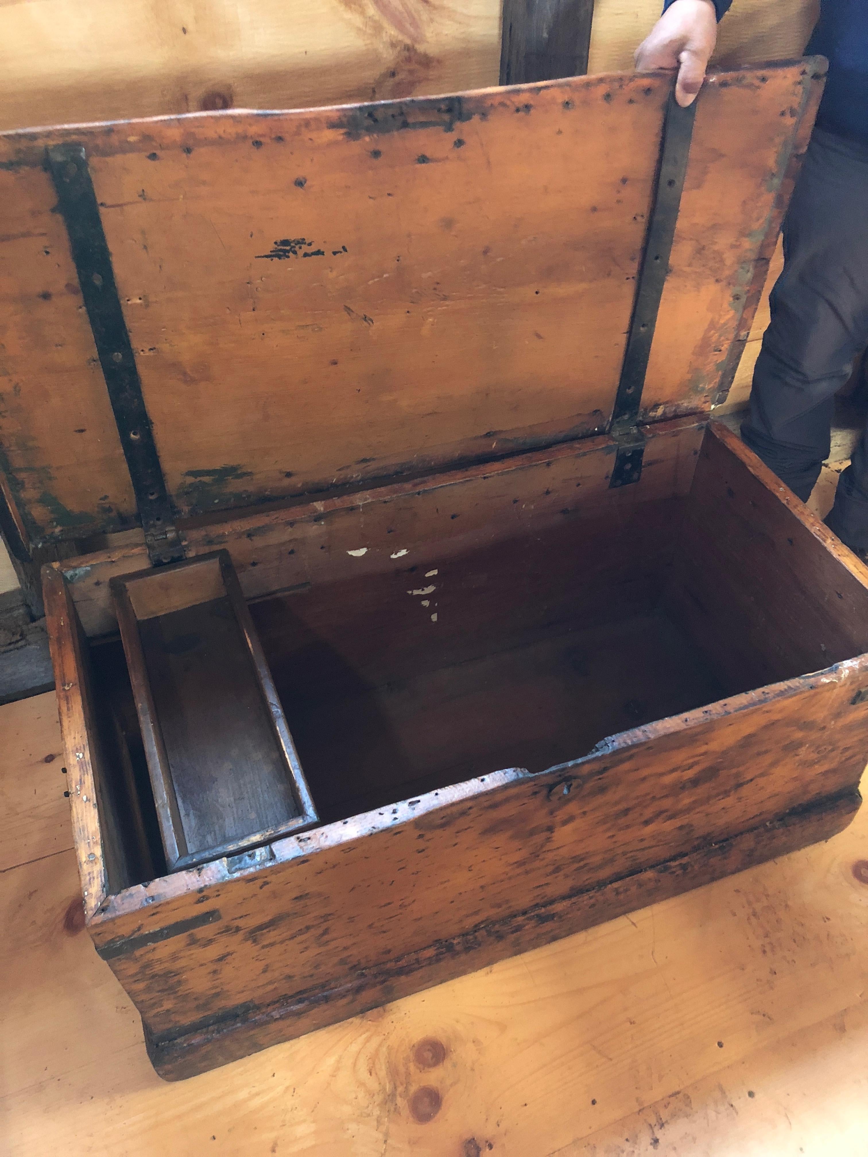 Super old and filled with character, a gorgeous wooden blanket chest with an amazing wood grained top, ripply from hand planing, and with the original dark iron hinges.