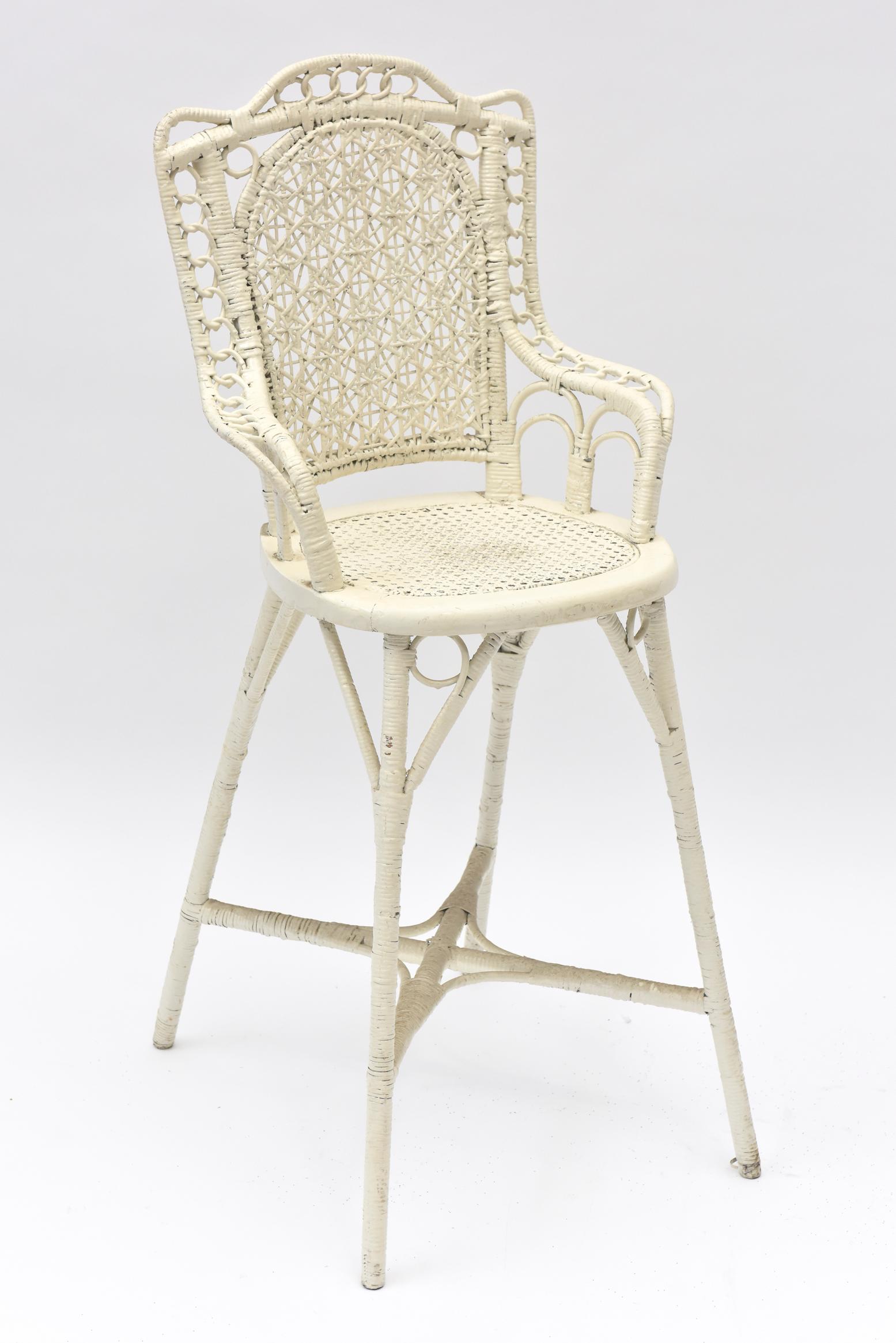 This Victorian Youth high chair has a spider woven back, cane seat and interlocking wicker circles on its arms. A product of the mid 19th century, few survived. This one was tenderly rewoven in the 1970s by a man who was deaf, dumb and blind, yet a