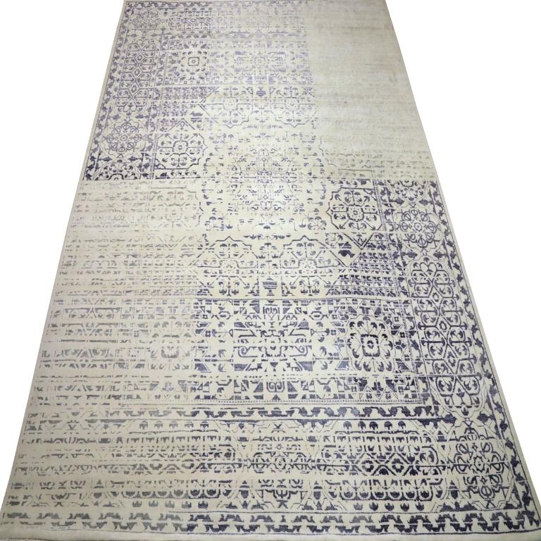 Prepare to be mesmerized by the profound visual depth of this modern/contemporary wool area rug, a genuine work of art where the interplay of light and dark threads creates a captivating three-dimensional feeling. Measuring an impressive 9 feet by