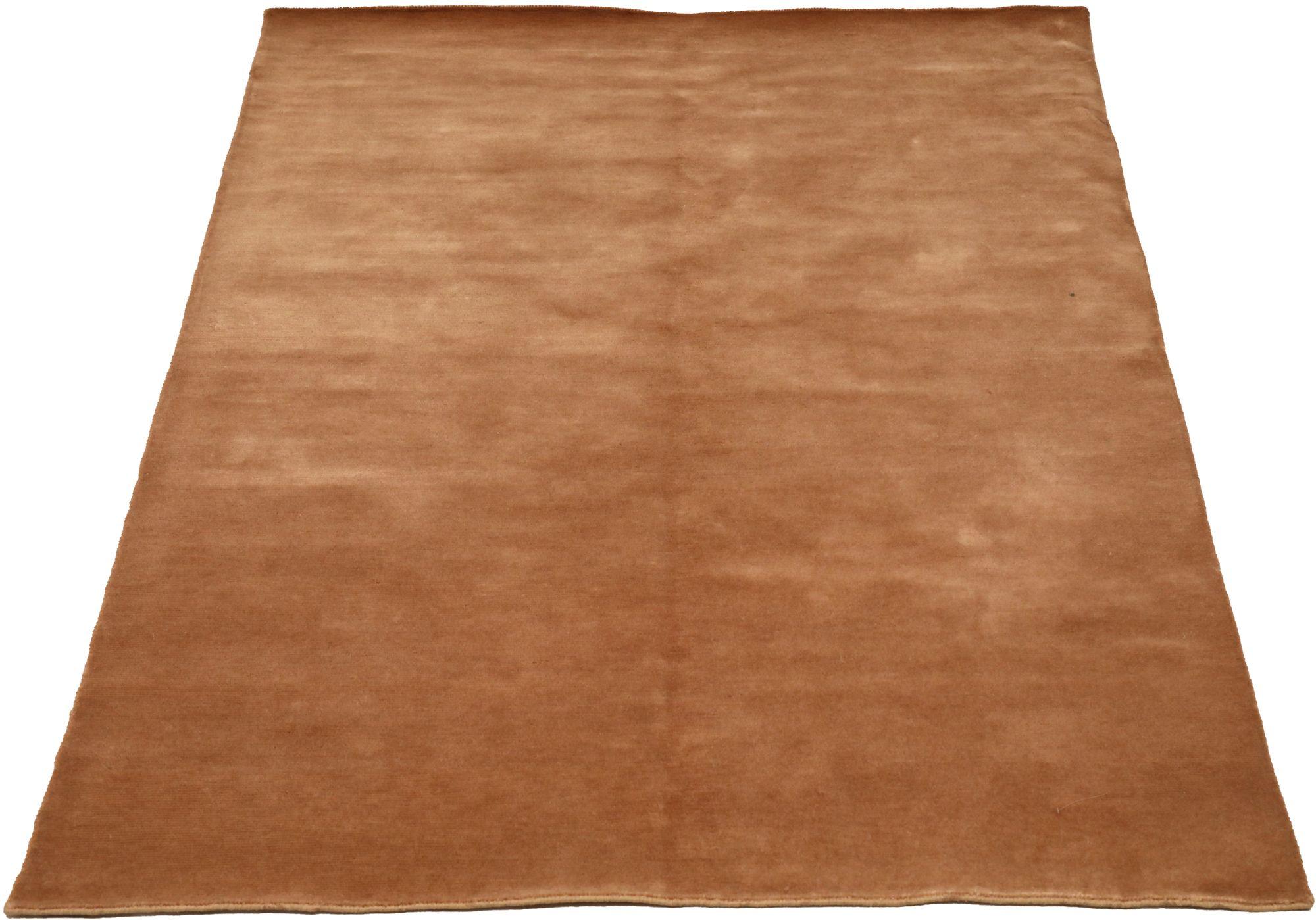 Indian Solid Small Rug: Warm Terracotta Hue

A Field of Luminous Warmth and Subtle Texture
This captivating Indian small rug immediately draws the eye. Its expansive field, in a luminous, warm terracotta hue, provides a radiant foundation. The rug's