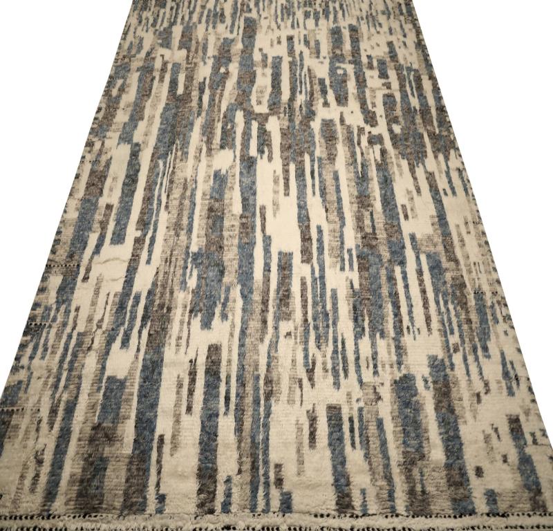 This exquisite Moroccan-inspired wool area rug stands as a genuine work of art, uniquely embodying contemporary design principles through its captivating use of diverse and harmonious colors.

Measuring an impressive 10 feet by 14 feet (120 inches x