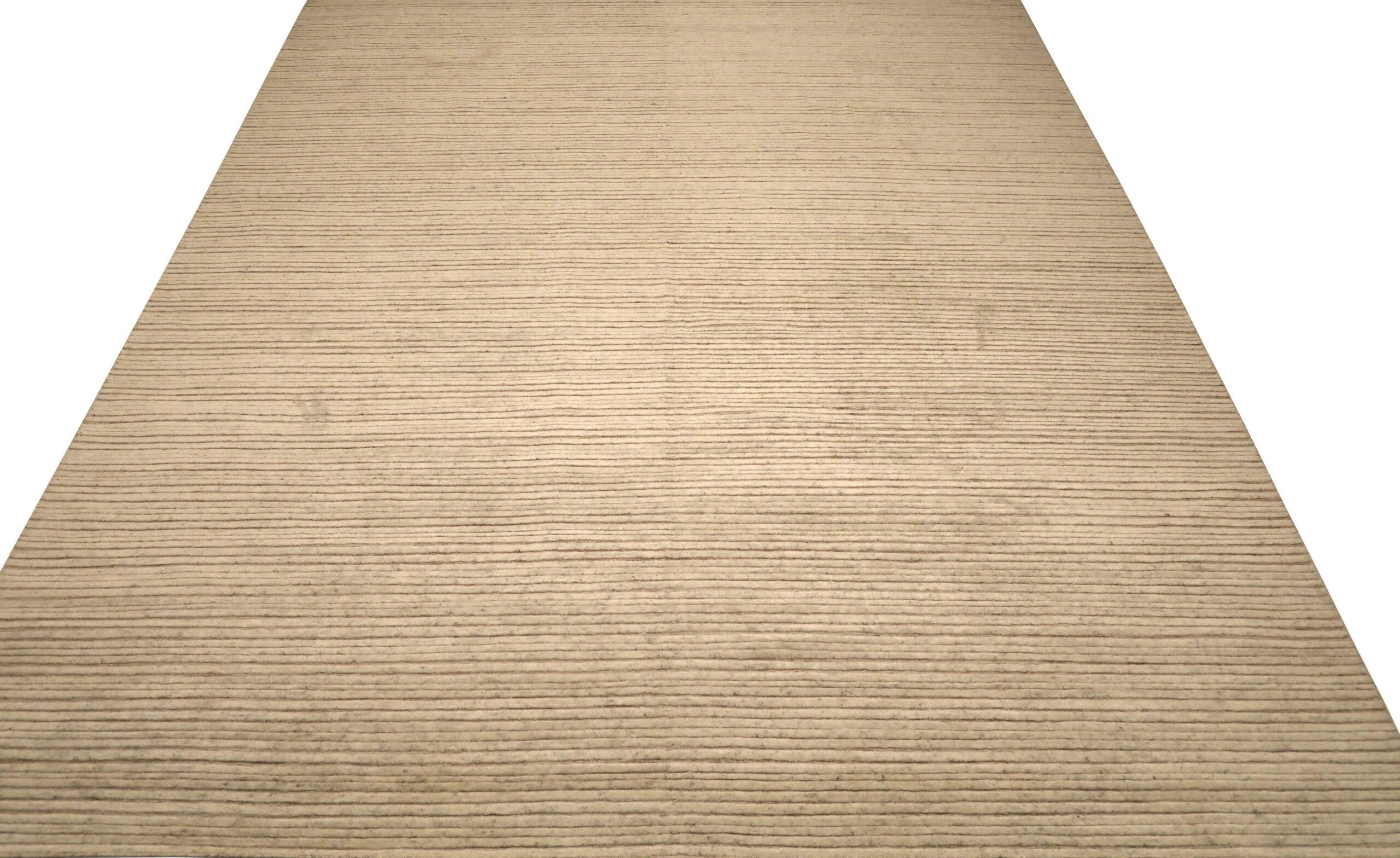 Indian Moroccan Area Rug: Cream & Subtle Striped Texture

A Field of Minimalist Grandeur and Subtle Texture
This captivating Indian Moroccan area rug immediately commands attention. Its expansive field, a soft, luminous cream, provides a serene