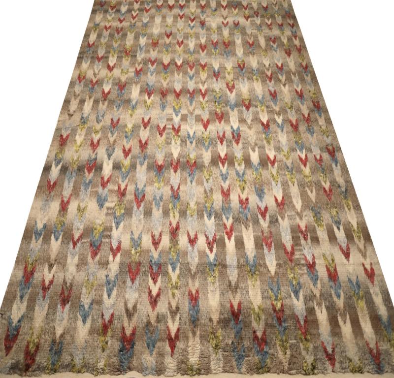 Scopri l'eleganza dell'India Moroccan caratterizzato da un tappeto over size del 1990. Progettato con lana e blu-verde-avorio-rosso, questo design esclusivo è perfetto per valorizzare il tuo spazio.