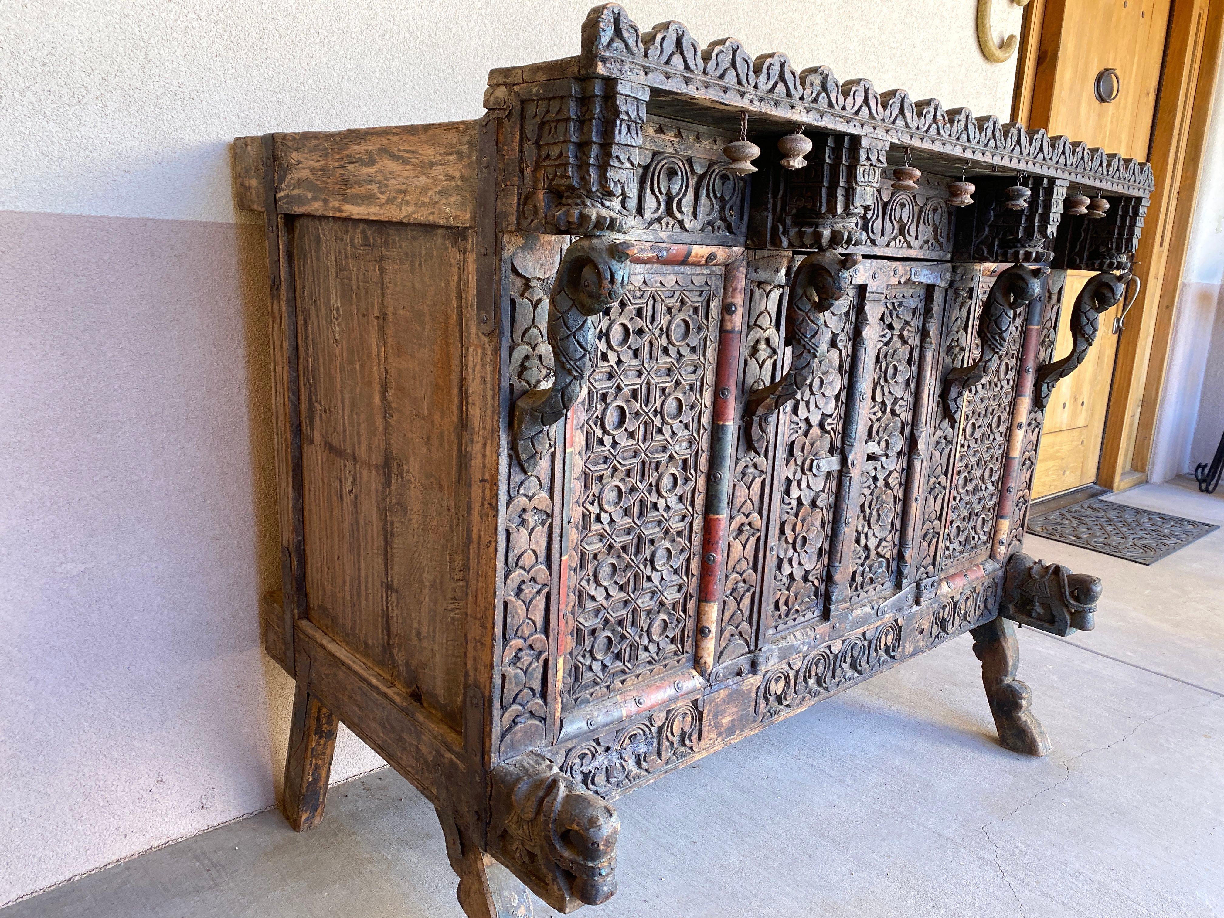 A beautiful accent piece, full of character, usable as a storage chest, side board, or simply for display, 19th century. Two-doors at front with original metal clasp. Panels to side of doors with decorative trim in blond, black and red stained wood.