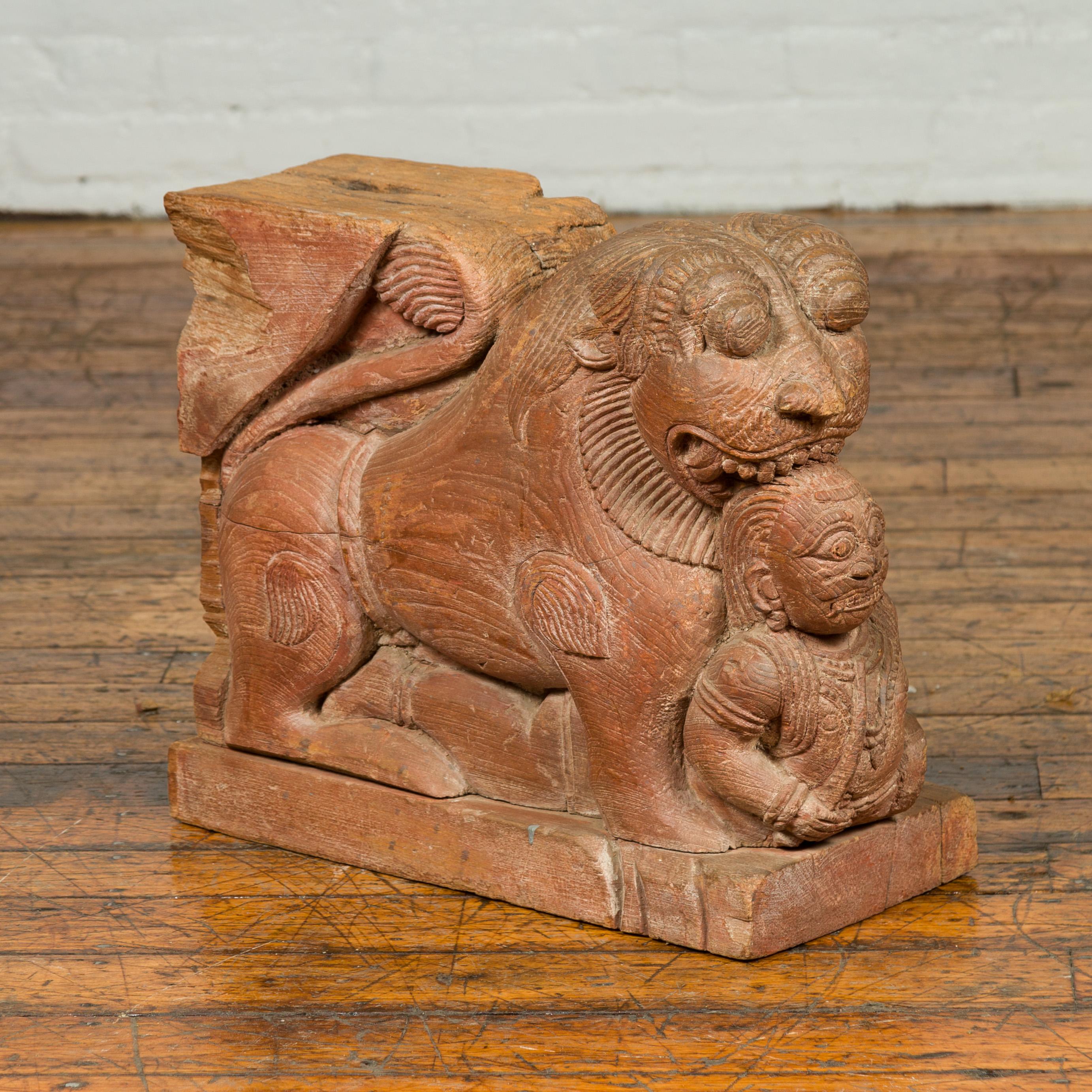 An Indian carved teak wood guardian lion sculpture from the mid-18th century, with traces of original paint. Handcrafted in India during the 1740s-1760s in order to take place in a monument, this teak architectural carving features a guardian lion,