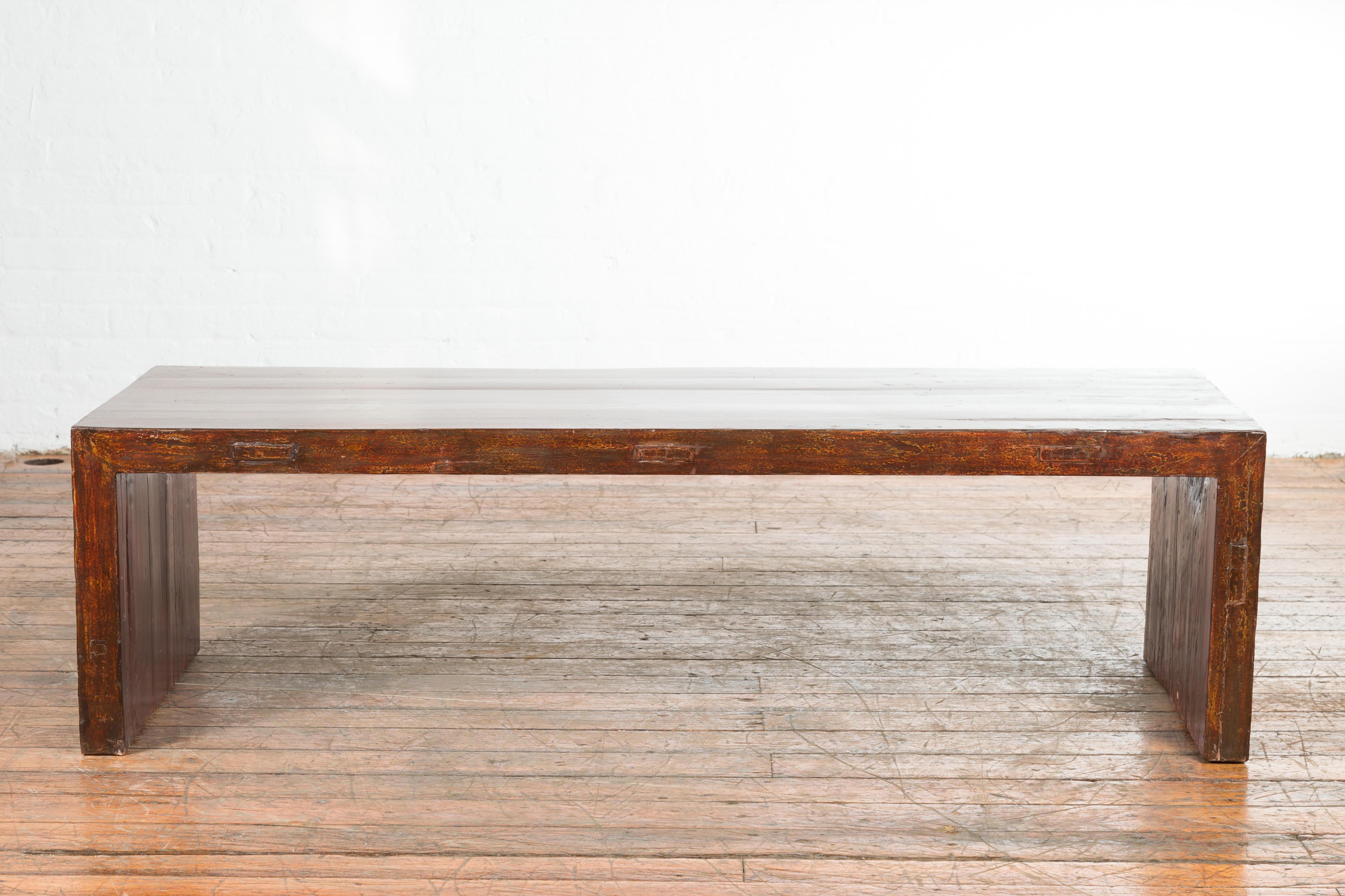 An Indian antique low altar console table from the 19th century, with underglaze snake skin pattern. Created in India during the 19th century, this low altar table features a rectangular top sitting above a linear base made of two solid supports on
