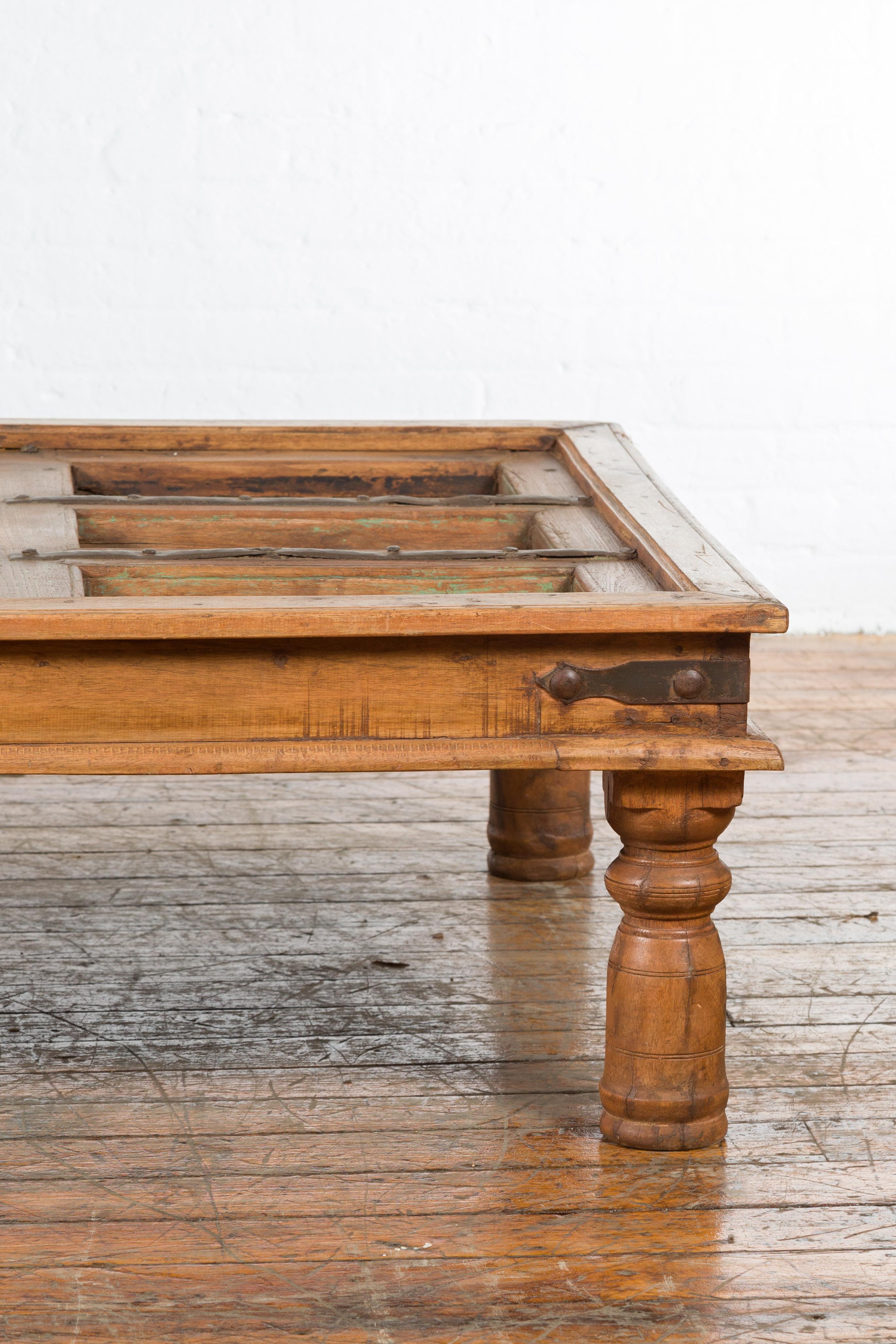 Wood 19th Century Indian Paneled Door with Iron Accents Converted into a Coffee Table For Sale