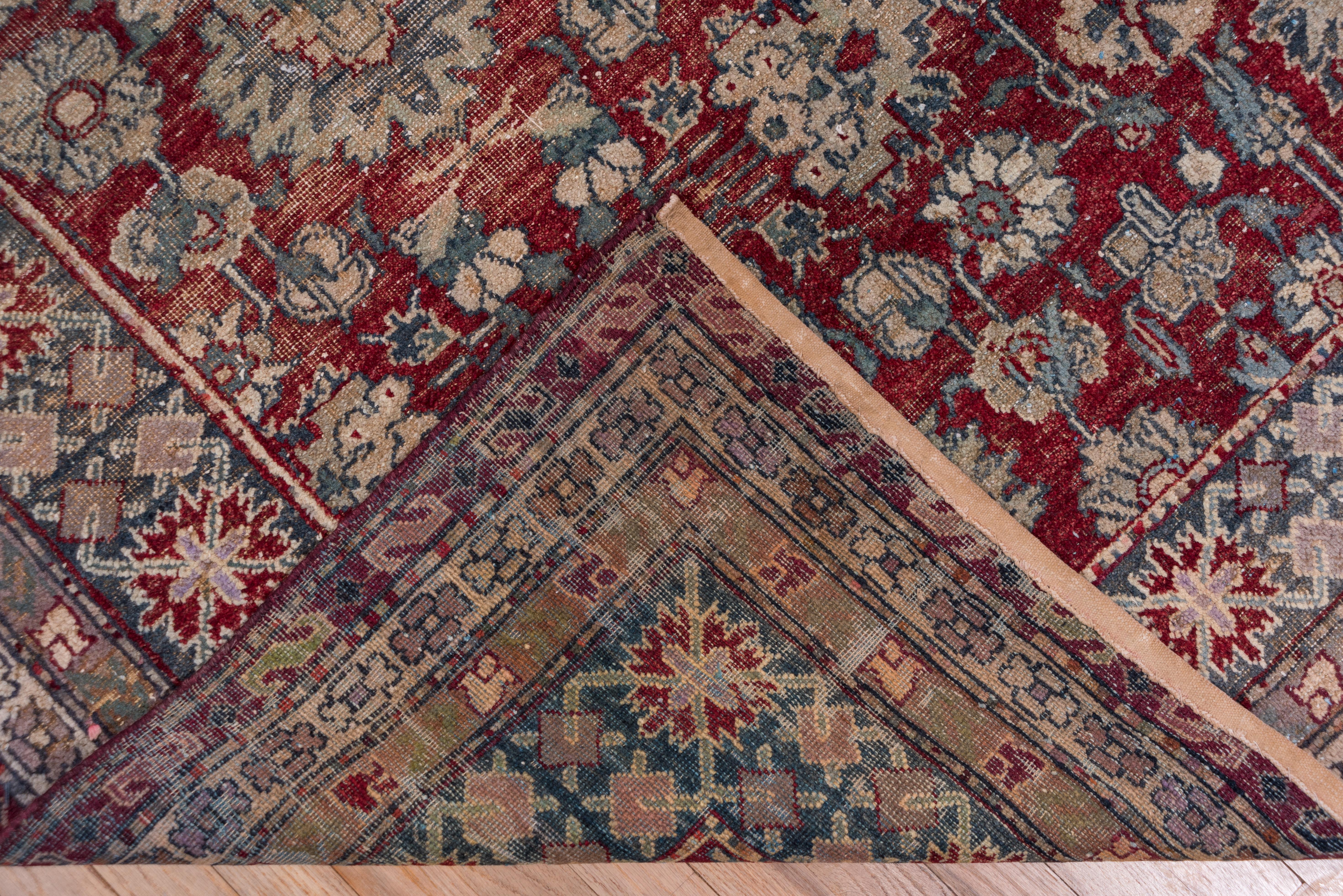 This northern Indian workshop carpet shows a well-organized all-over palmette pattern with a six palmette central axis and secondary six-palmette side axes. Four quarter symmetric with a rich burgundy red ground. Green, straw and buff details.