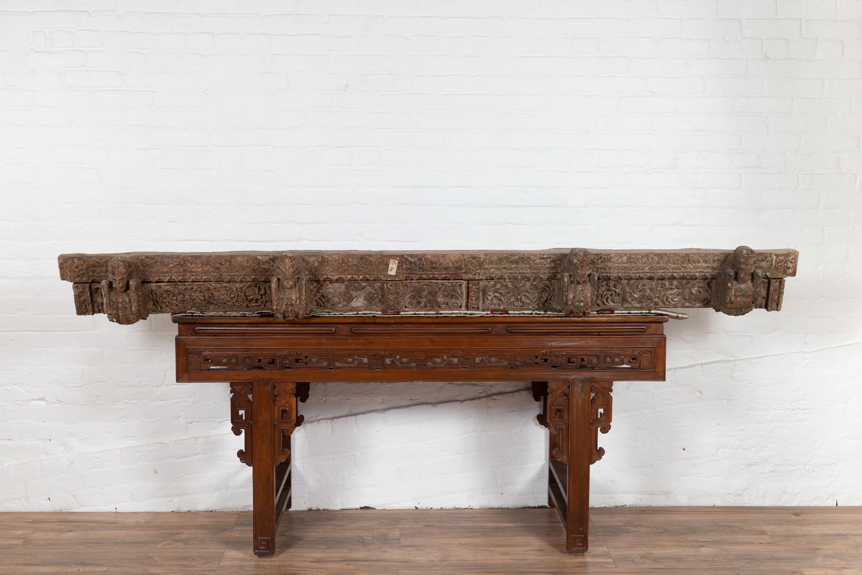 An antique 19th century architectural molding from an Indian temple with carved animals and foliage. Born in India during the 19th century, this horizontal cornice features carved protruding animals standing out beautifully on foliage adorned
