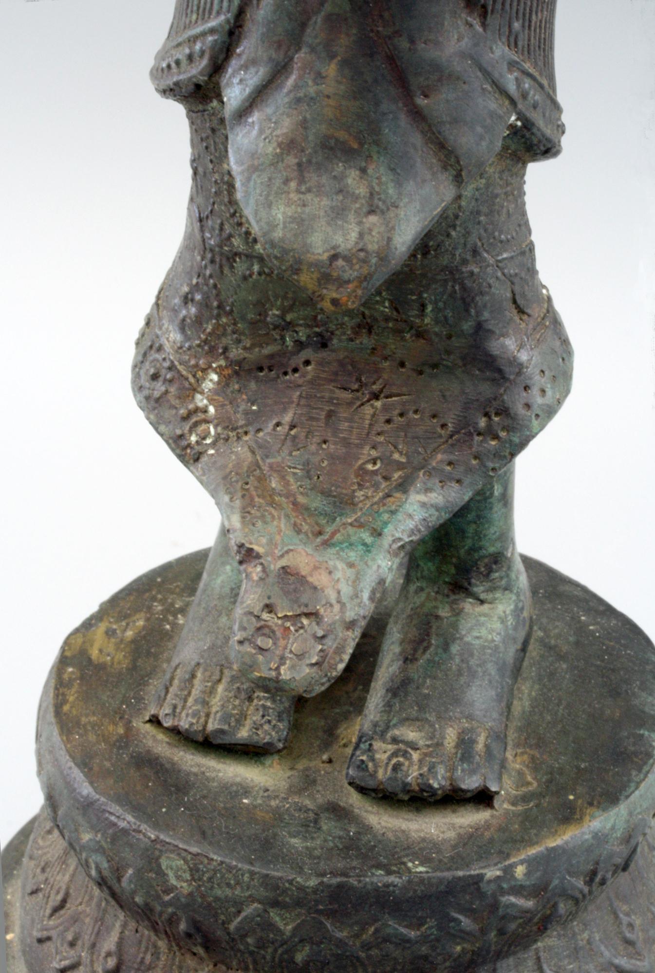 Cast Indonesian Antique Bronze Figure of a Slender Goddess with Lotus Flower
