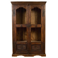 Indian Antique Cabinet with Pierced Doors, Carved Motifs and Bronze Spindles