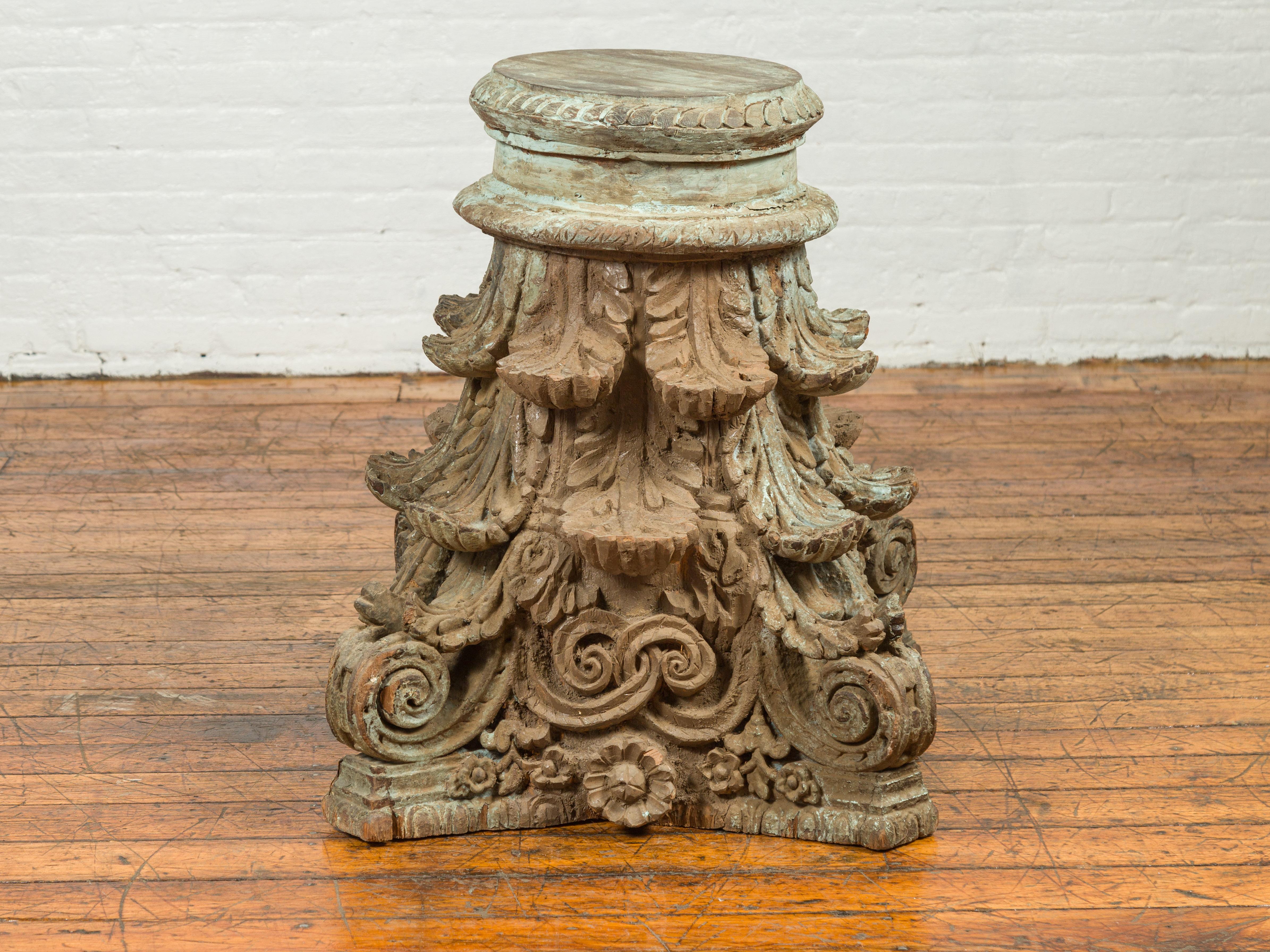 An antique Indian Corinthian temple capital from the 19th century, with distressed patina. Immerse yourself in the rich cultural heritage of Indian architectural history with this 19th century Indian Corinthian temple capital. As a remarkable piece