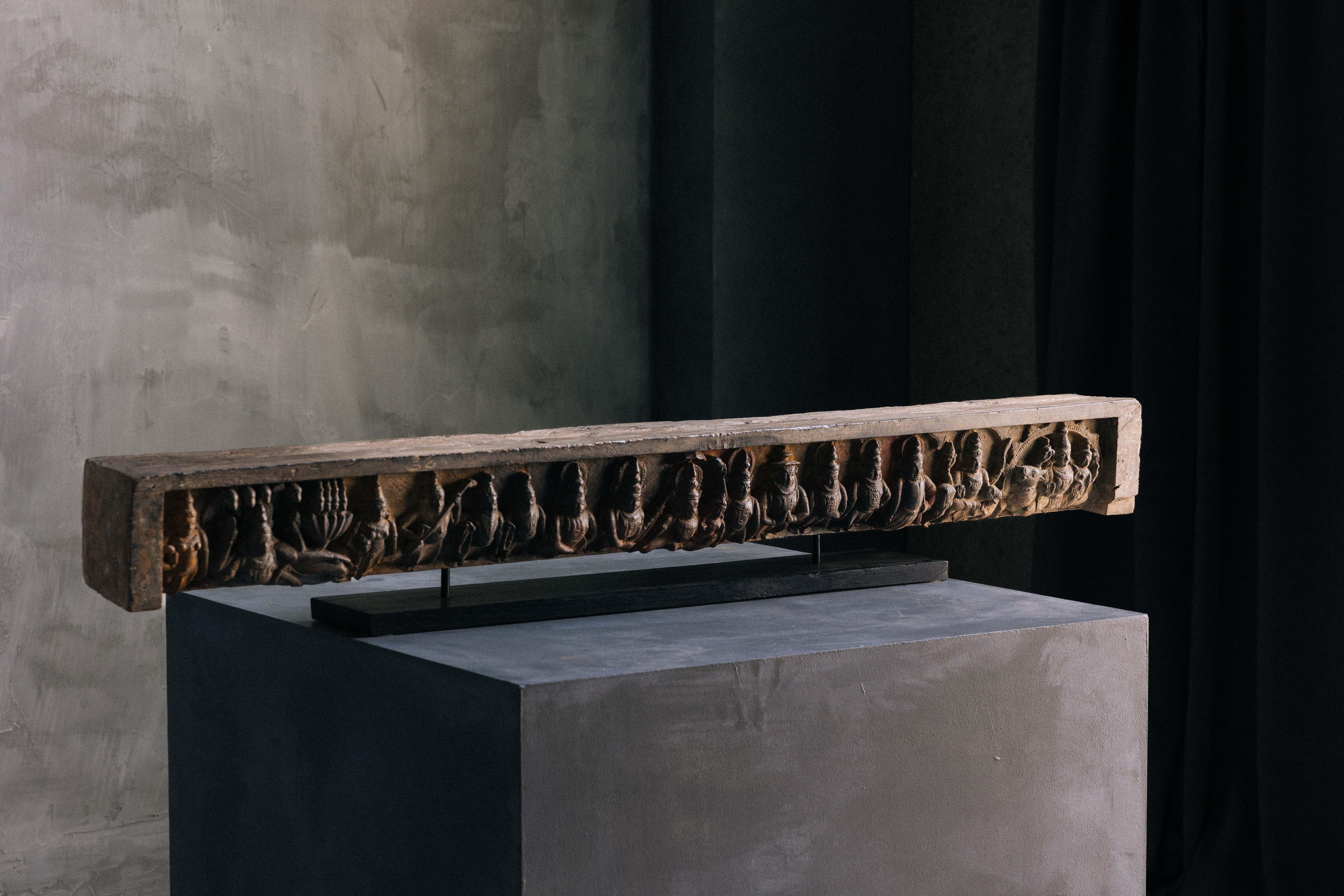 Exquisite long relief sculpture, embodying Indian antiquity, resting regally on a sleek pedestal. Crafted with meticulous detail, it features intricate designs inspired by ancient Indian artistry. This magnificent piece serves as a striking