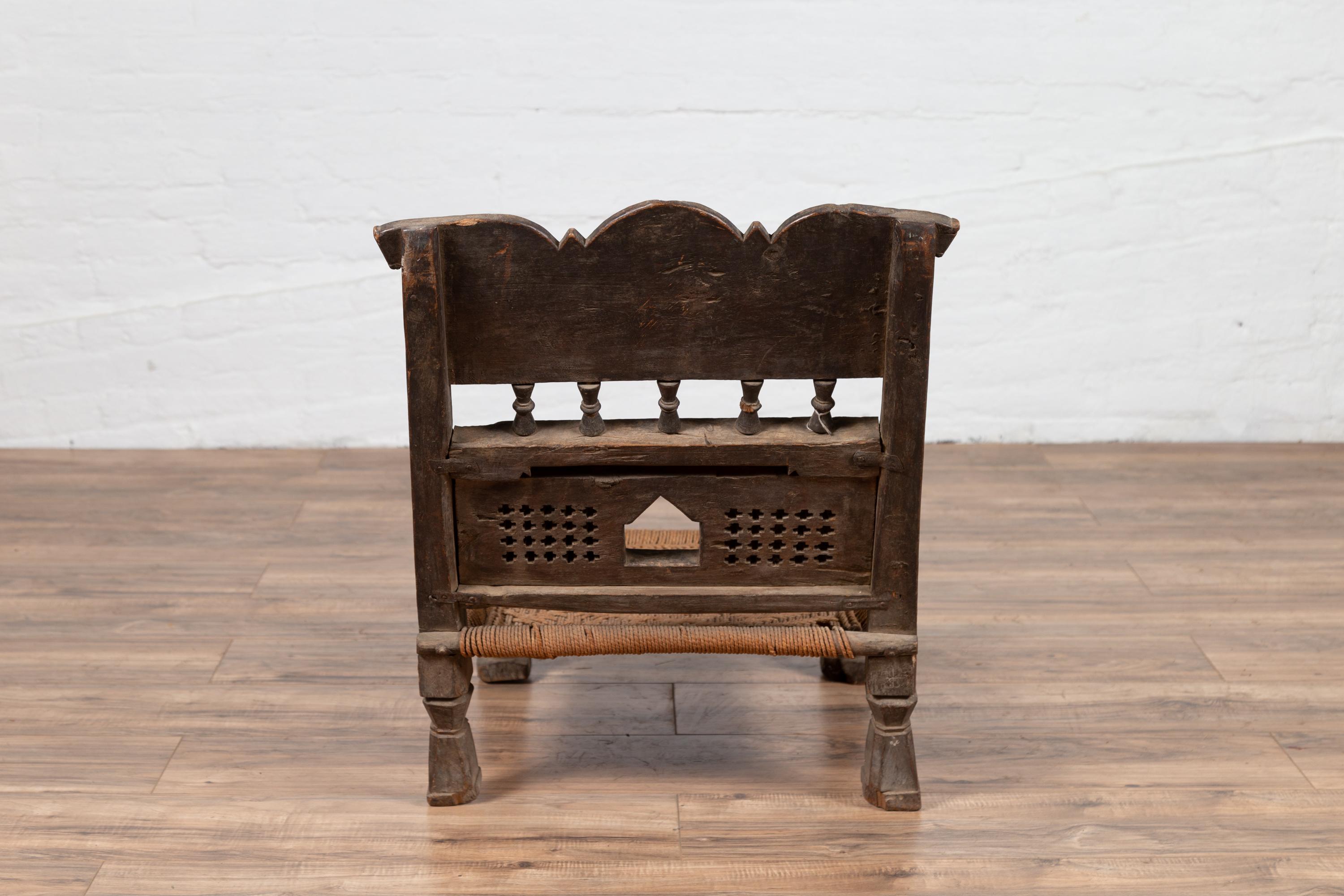 Indian Antique Rustic Low Seat Wooden Chair with Carved Rosettes and Rope Seat For Sale 6