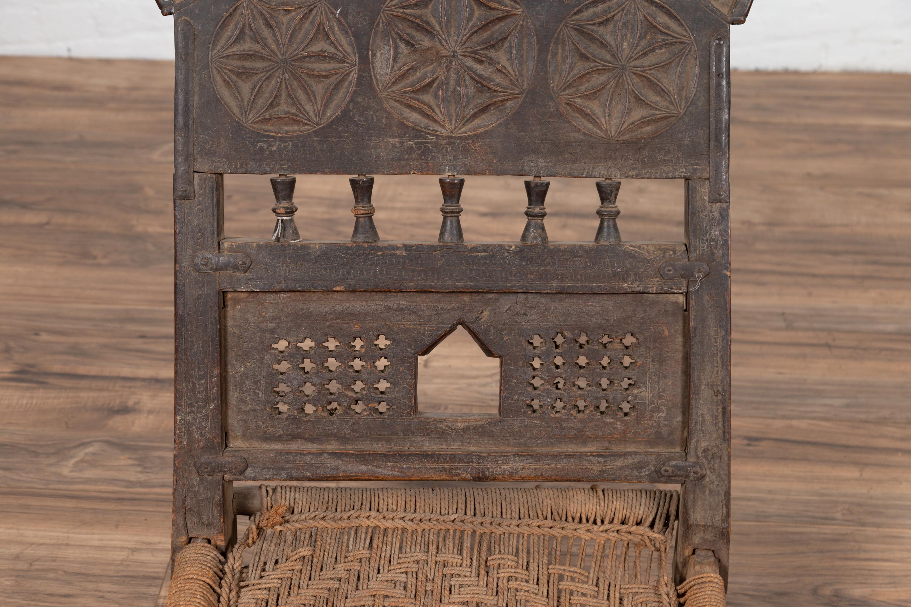 Hand-Carved Indian Antique Rustic Low Seat Wooden Chair with Carved Rosettes and Rope Seat For Sale