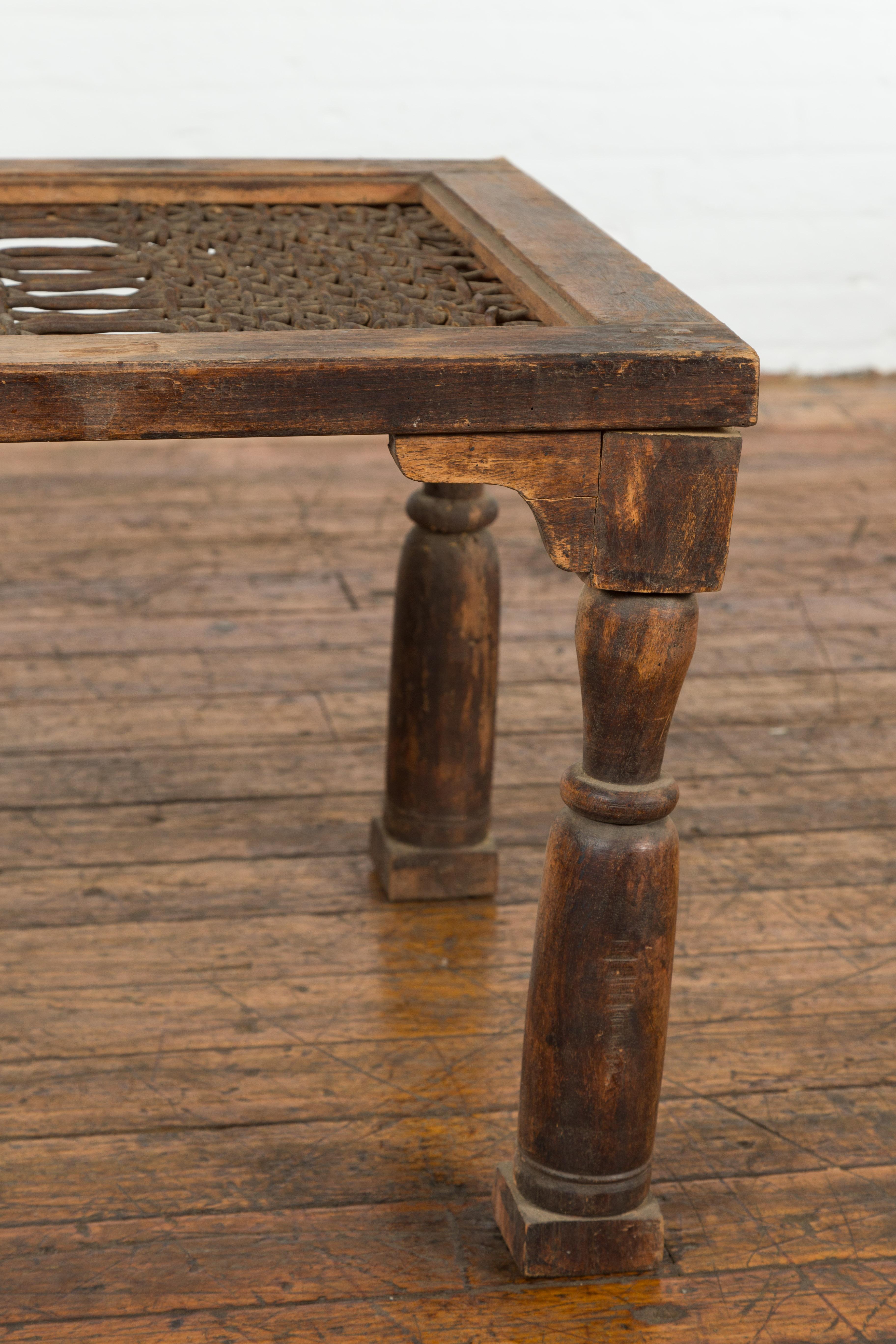Iron Indian Antique Window Grate Made into a Coffee Table with Turned Baluster Legs For Sale
