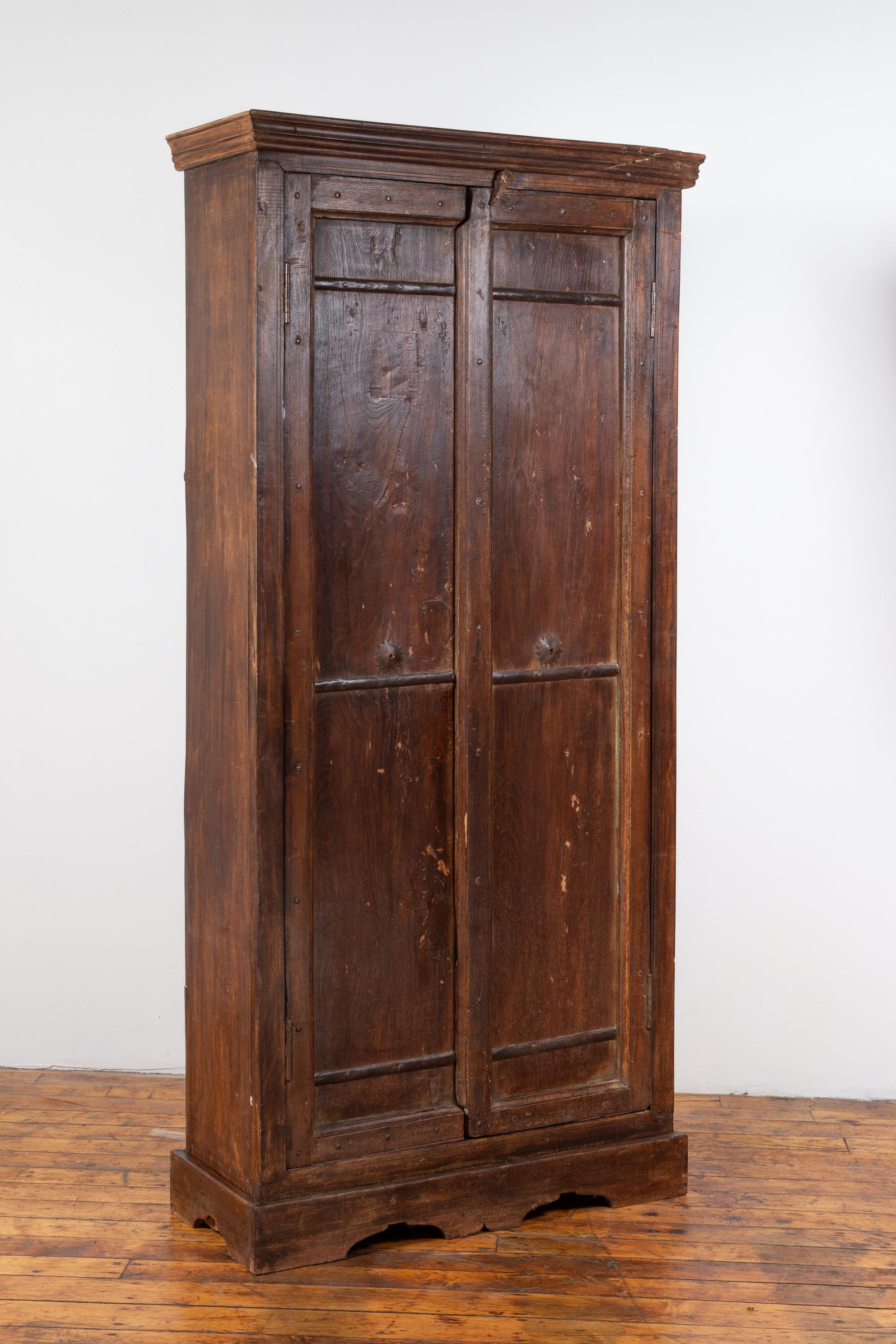 Indian Antique Wooden Armoire with Paneled Doors, Metal Braces and Aged Patina In Good Condition In Yonkers, NY