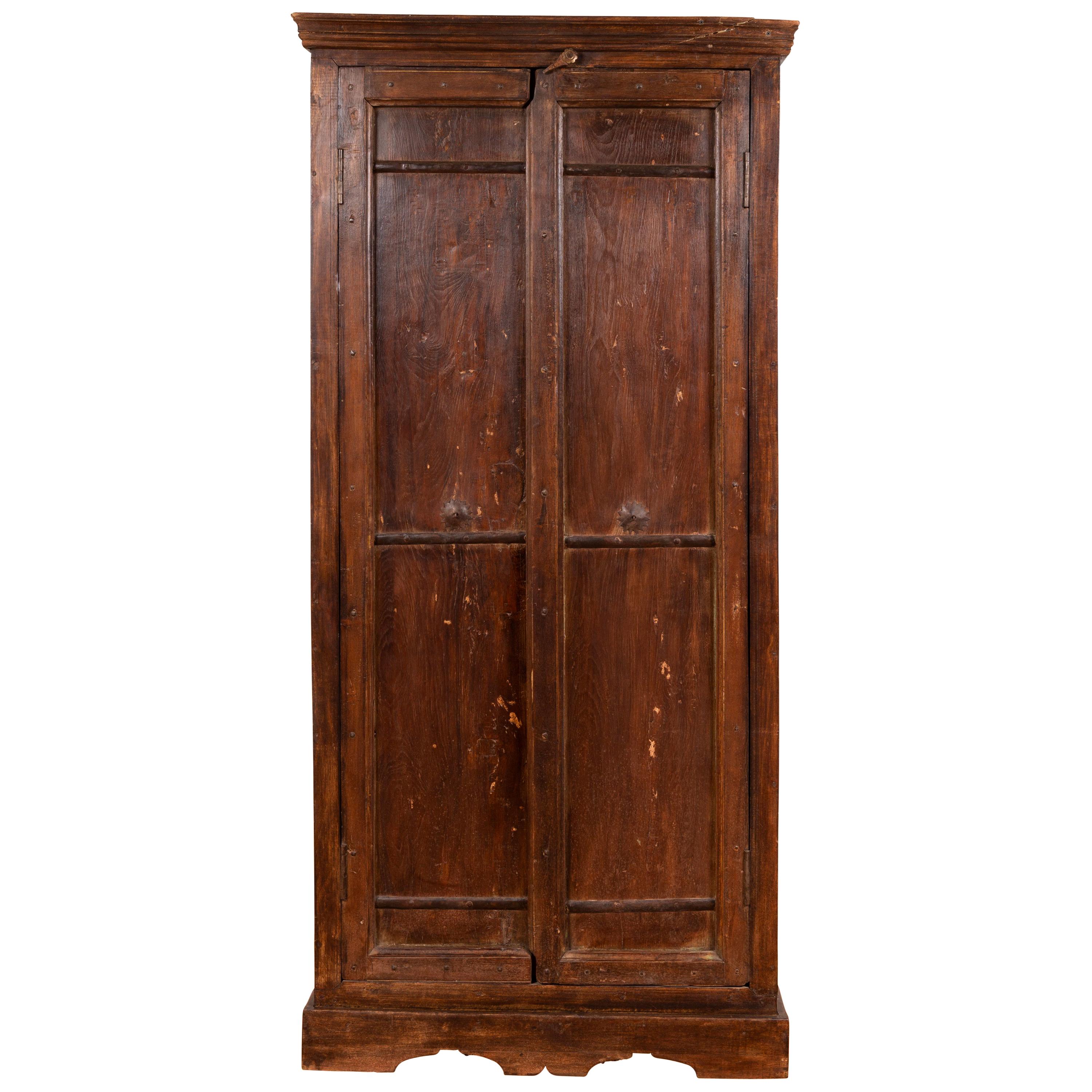 Indian Antique Wooden Armoire with Paneled Doors, Metal Braces and Aged Patina