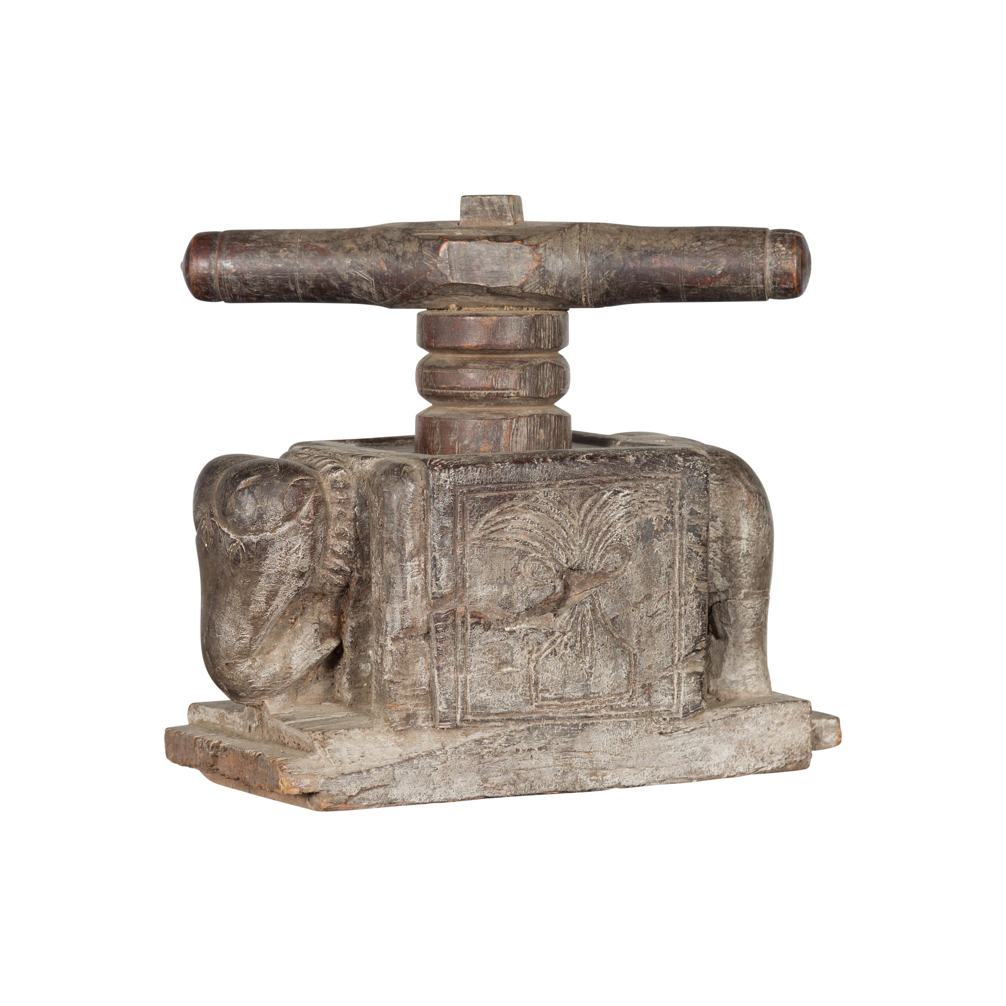 An Indian antique carved wooden hand noodle press from the 19th century, with elephant motif. Created in India during the 19th century, this wooden piece was originally used to hand make noodles. Showcasing a vice press, the body is adorned with a