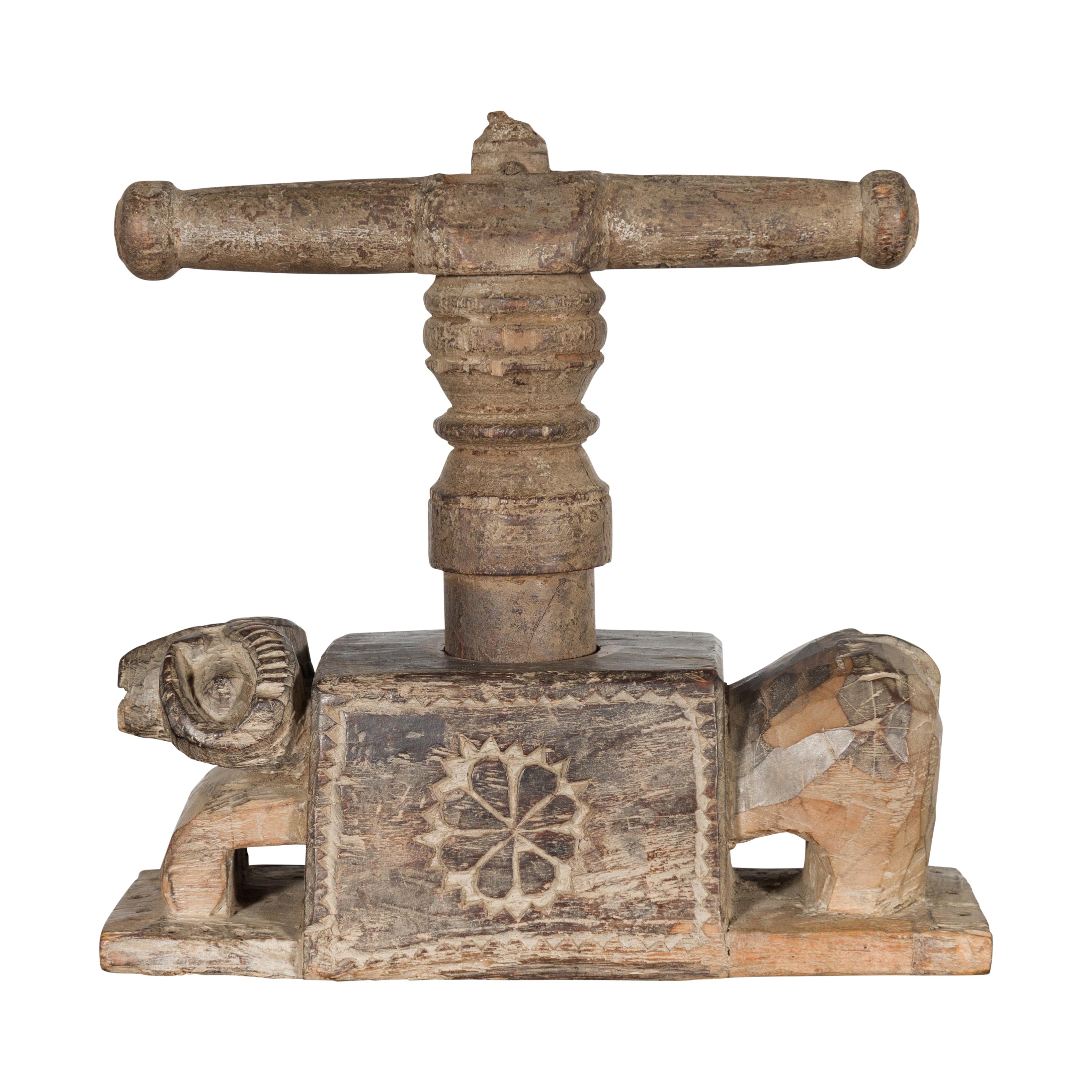 An Indian antique carved wooden hand noodle press from the 19th century, with ram motif. Created in India during the 19th century, this wooden piece was originally used to hand make noodles. Showcasing a vice press, the body is adorned with a carved