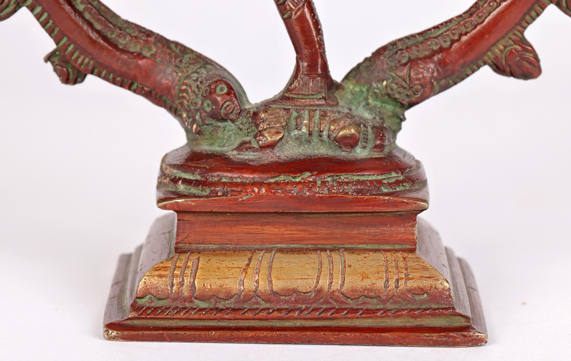 A fine and unusual vintage Asian Indian red lacquered bronze statue of Shiva Nataraja dating from the 20th century. The figure represents the Hindu God Shiva performing a dance. The figure is mounted on a rectangular pedestal base and stands on top