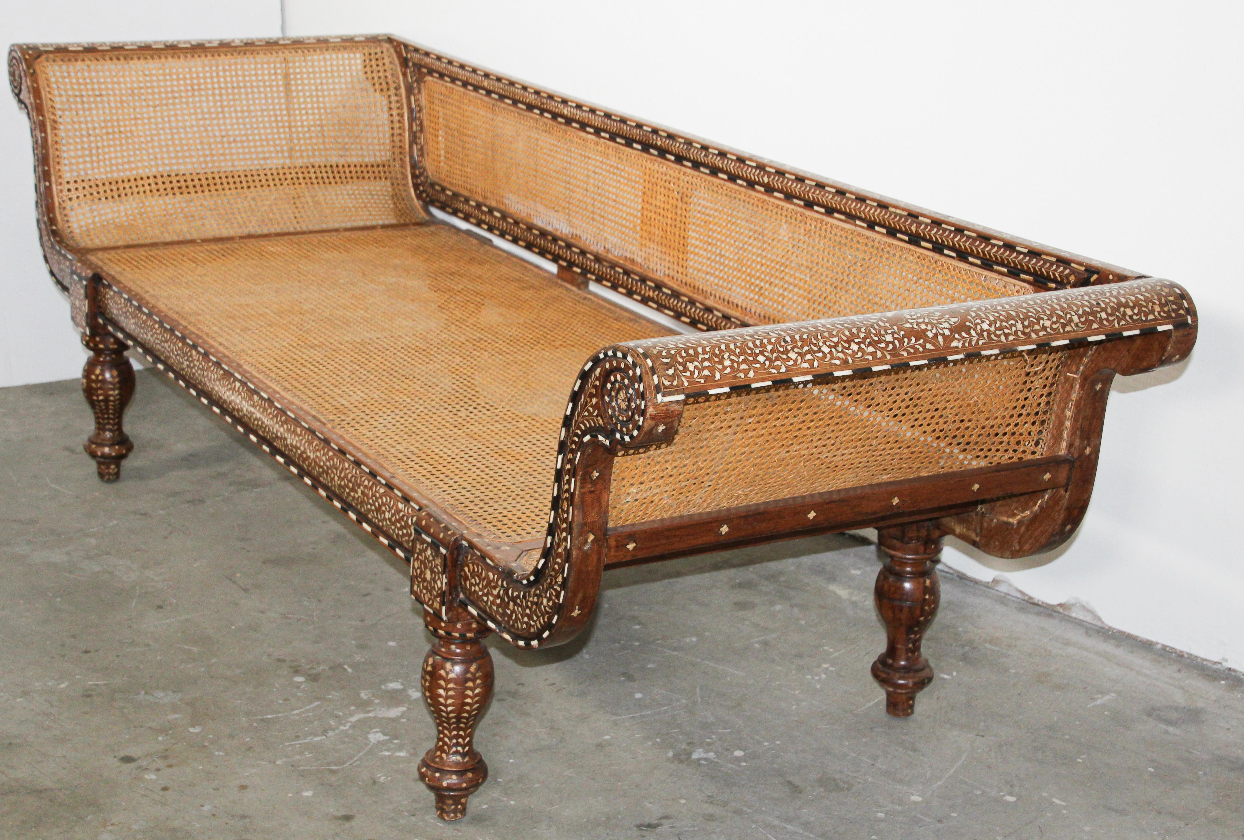 Large Antique hand carved Anglo-Indian sofa, day bed, heavily inlaid with bone.
The Anglo Indian colonial sofa is inlaid with bone and ebony inlays throughout.
Anglo-Indian settee bench handcrafted from hardwood, and wonderfully hand carved and