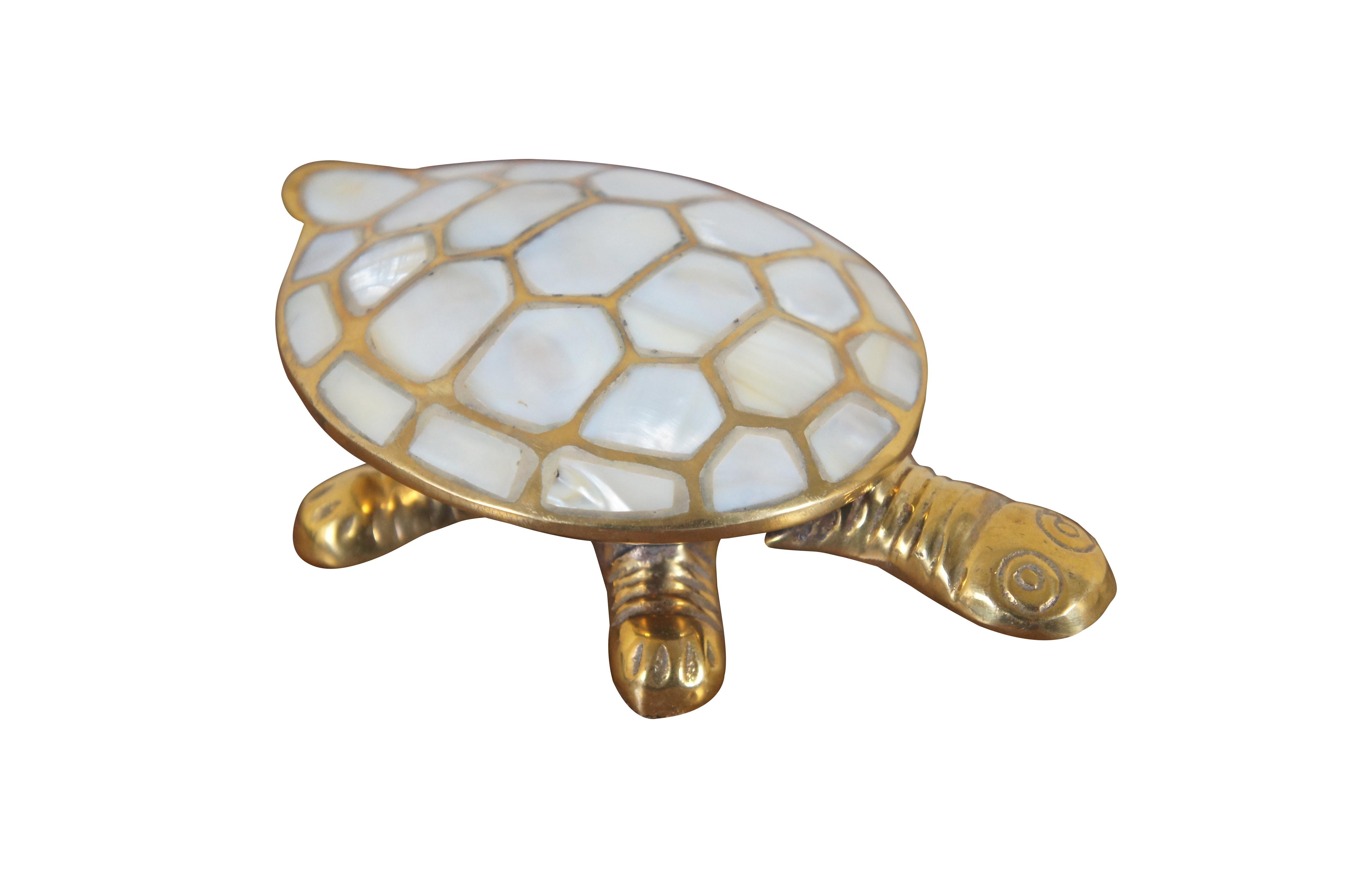 Vintage large brass trinket box in the shape of a turtle / tortoise with mother of pearl inlaid shell. Made in India.

Dimensions:
6.25