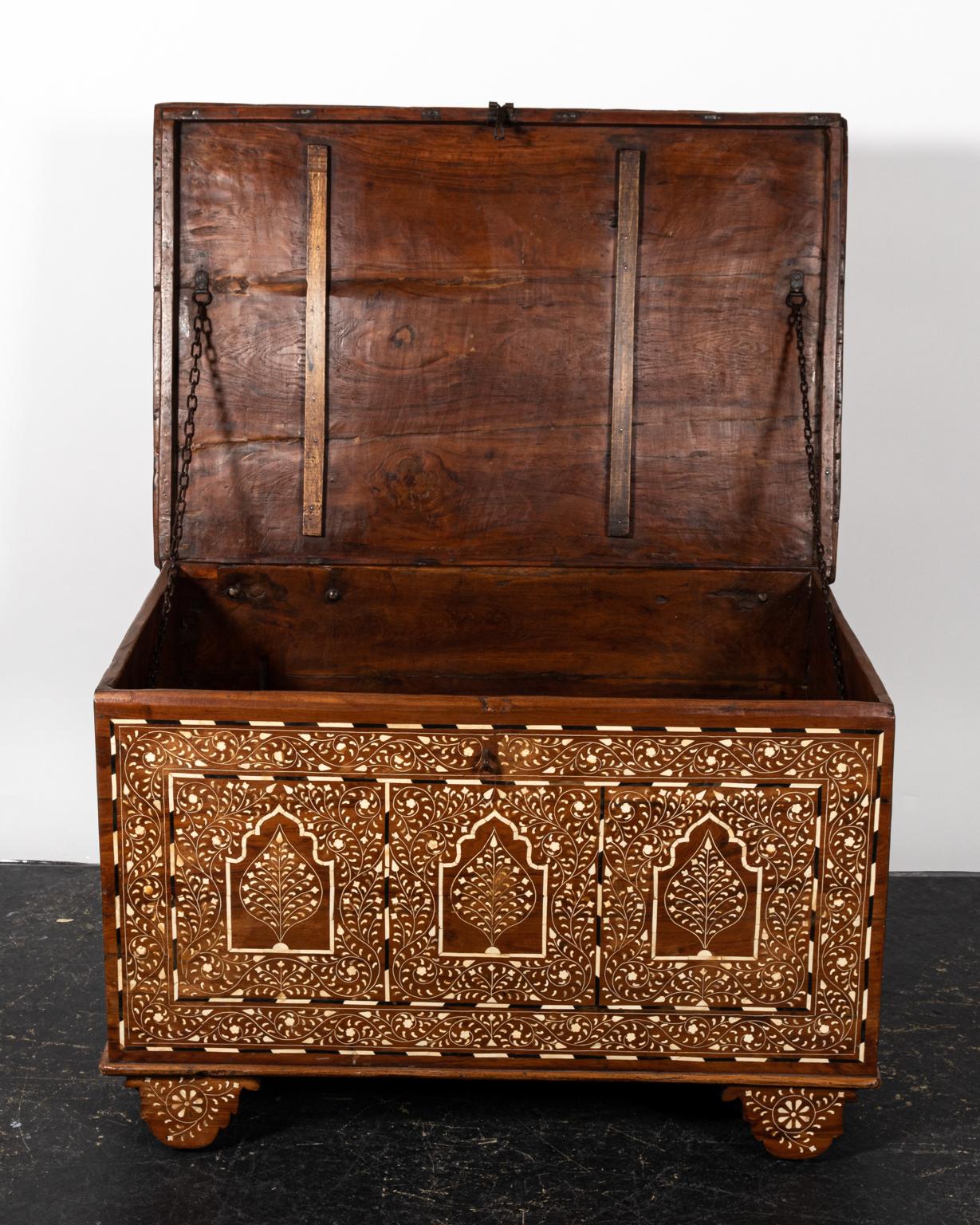 Indian wooden trunk with camel bone inlay on castors. Please note of wear consistent with age.