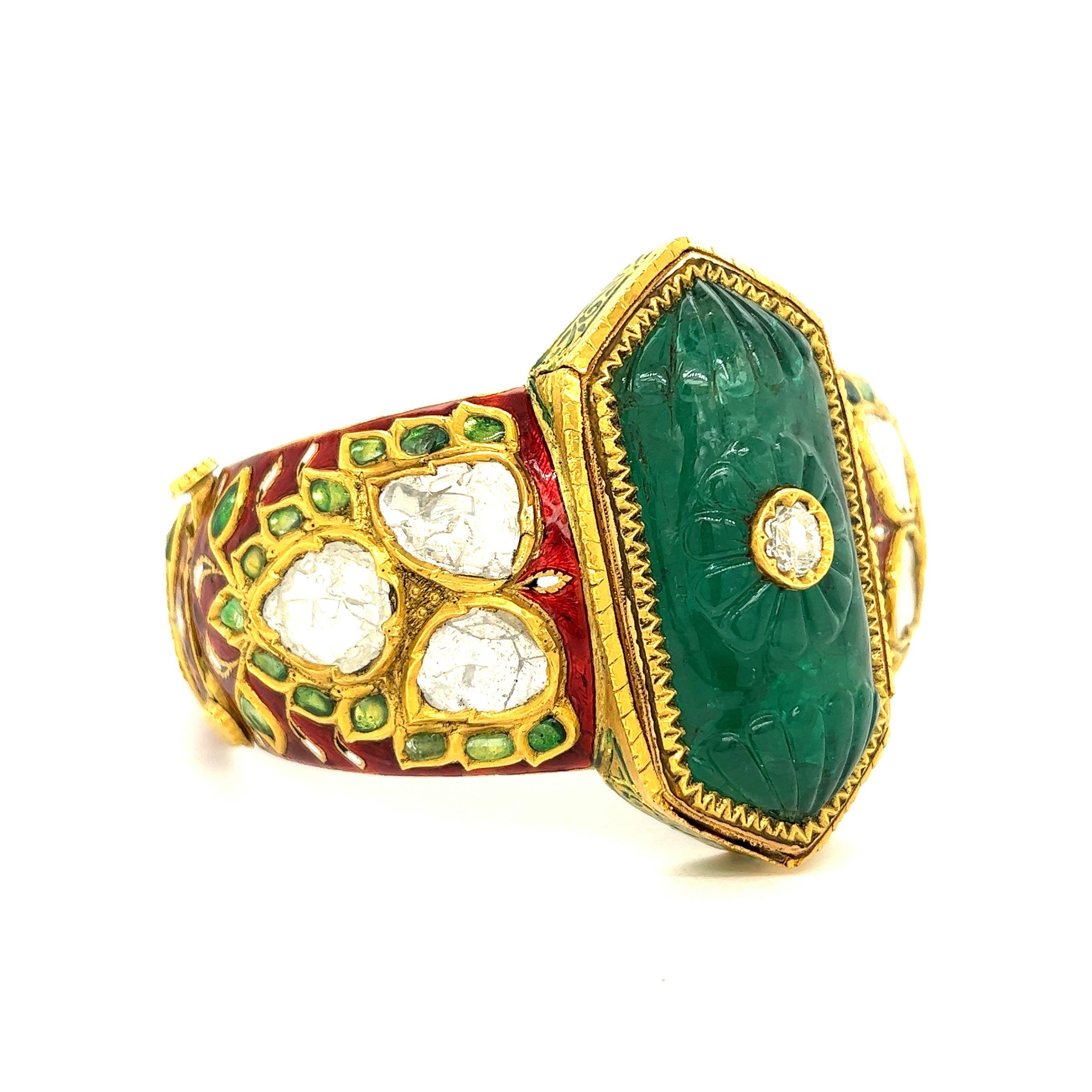 Indian Carved Emerald Diamond Enamel Bangle Bracelet

Carved emerald of approximately 45-50 carats, rose-cut diamonds of approximately 6-8 carats total, featuring transparent red enamel set on yellow gold; center piece emerald (4.8 cm x 2.7
