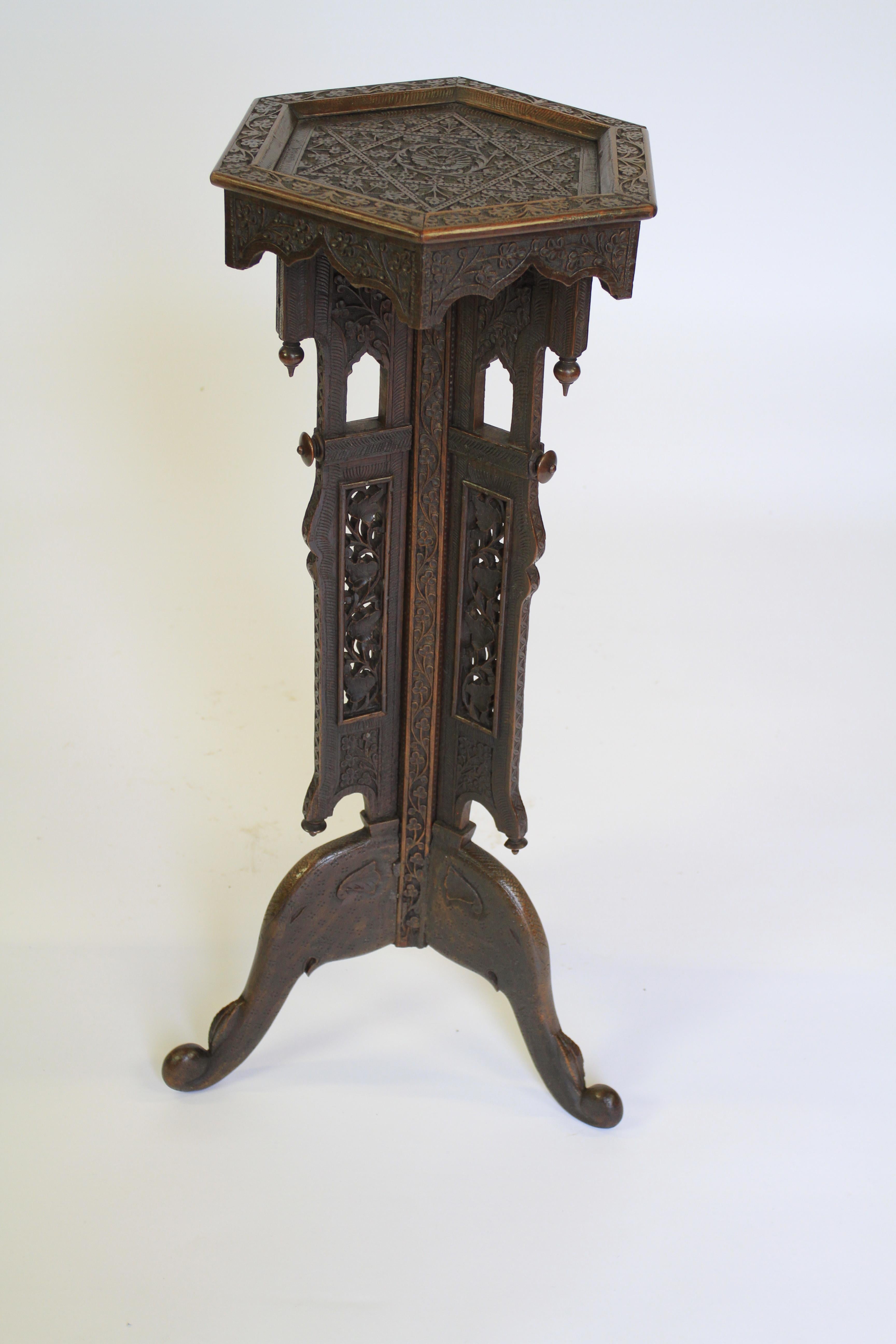Indian Carved Lamp Table circa 1930s
Hexagonal carved top
Centre pedestal with 3 open pierced carved Panels
Sitting on Tripod Elephant Head shaped Legs
Good quality carving
