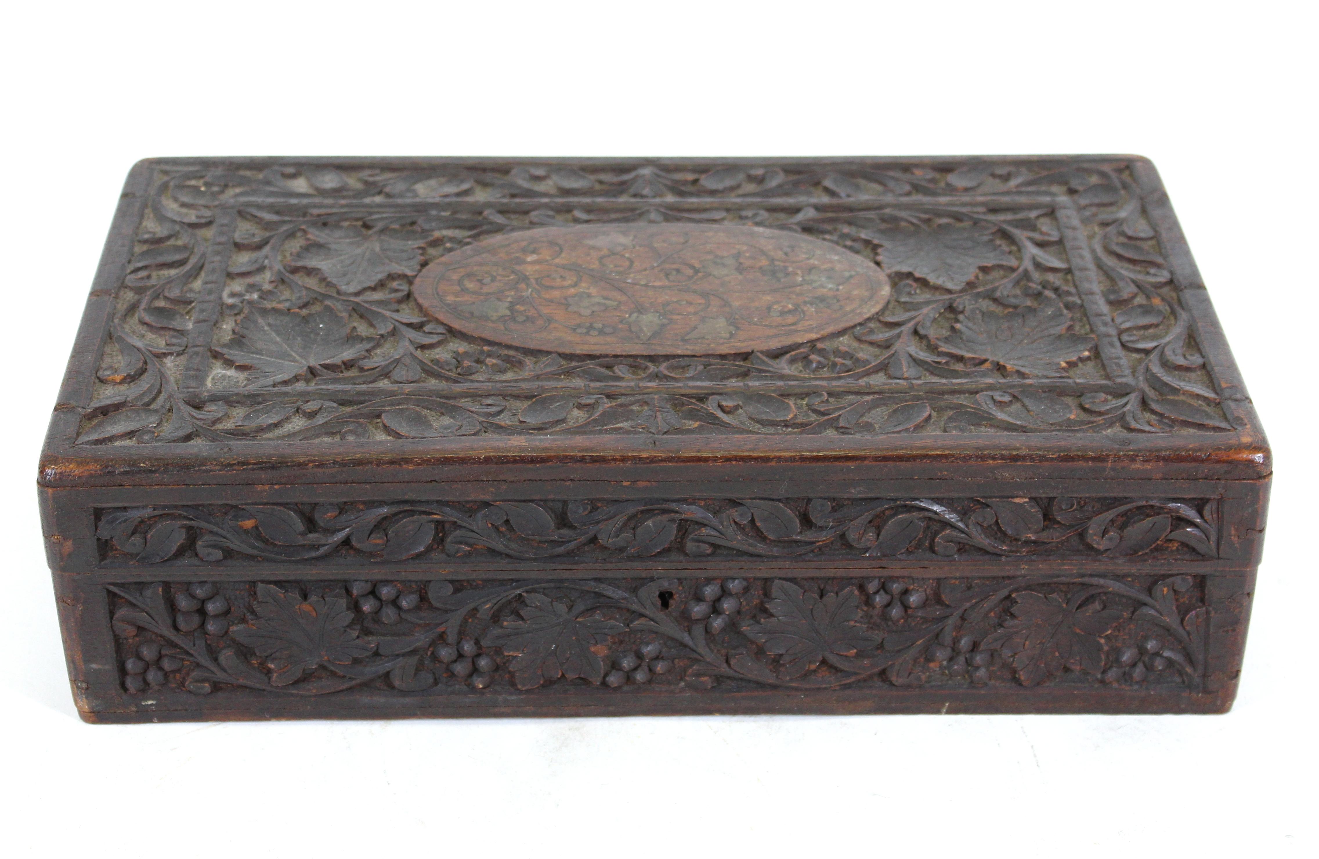 Indian antique carved wood humidor box with ornamental metal inlay.