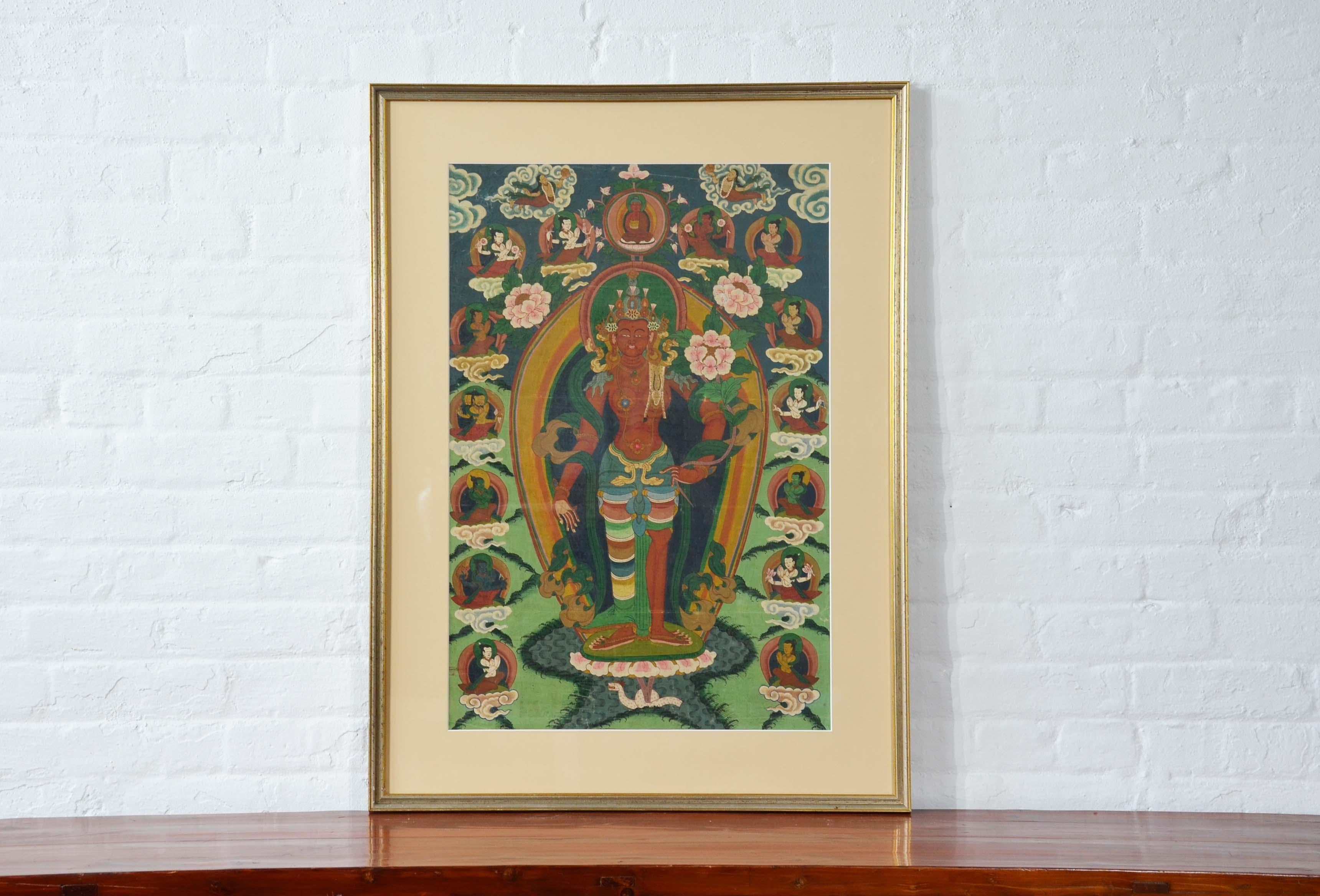 A framed Indian ceremonial Hindu deity from the mid 20th century, hand-painted on canvas. Created in India during the midcentury period, this scene, hand-painted on canvas and set inside a gilded frame and secured under glass, depicts a female deity